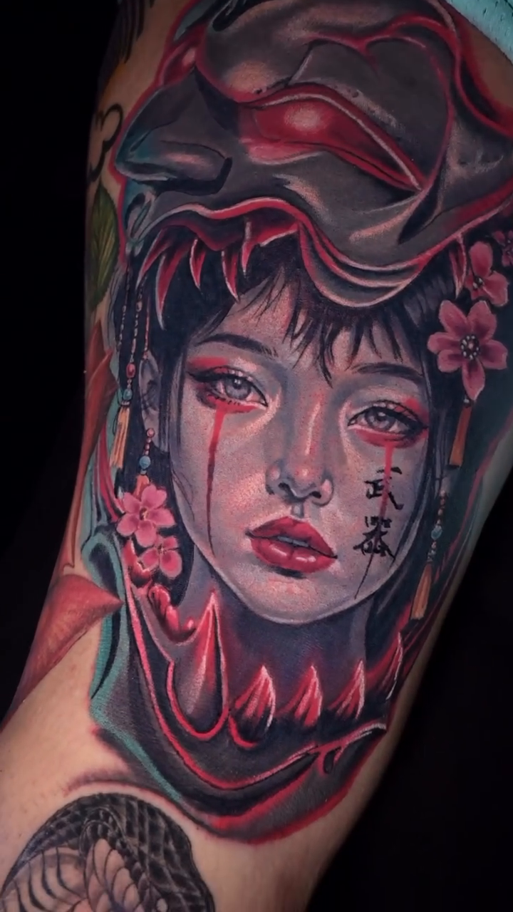 Geisha with demon mask neo-traditional tattoo on the upper arm by William Pollock
