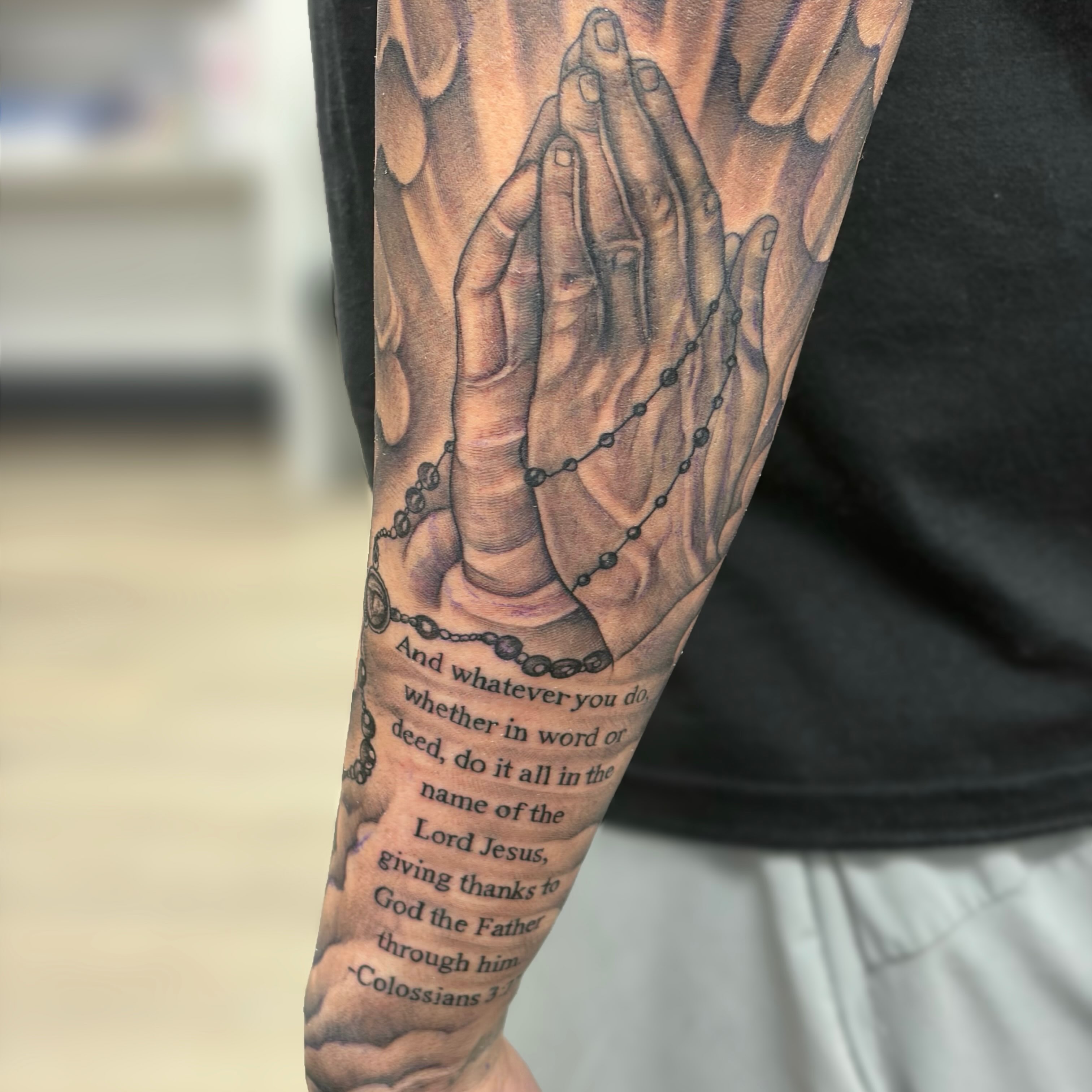 Praying hands with rosary realism tattoo on the forearm by Dallas Tattoo Artist