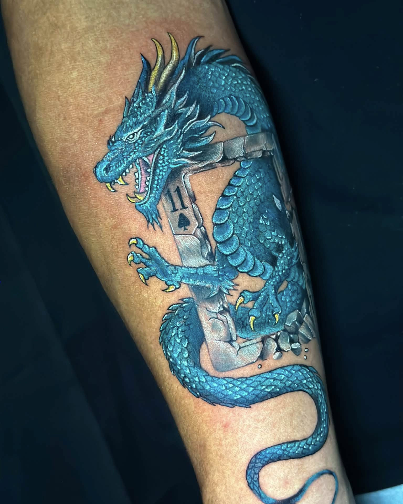 Blue dragon realism tattoo on the forearm by Stephen Degracia