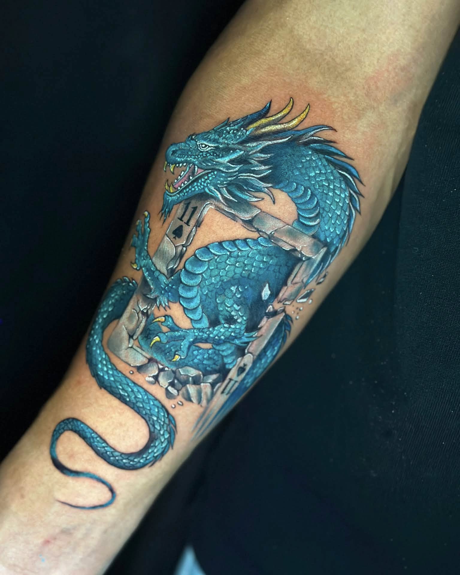 Dragon realism tattoo on the forearm by Stephen Degracia