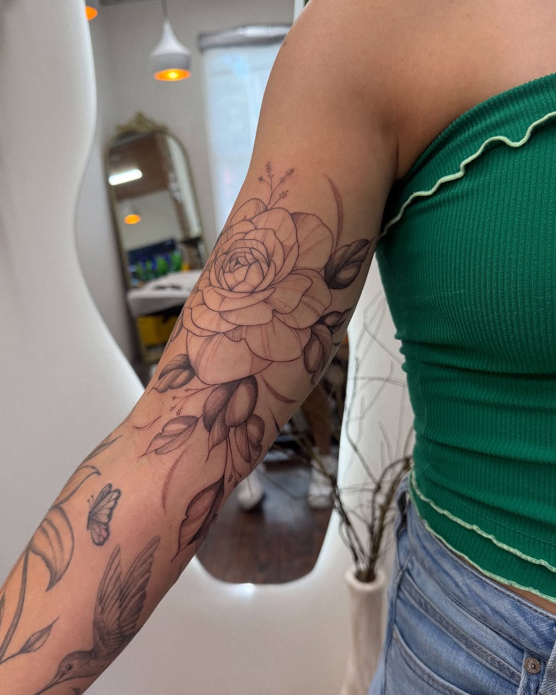 Rose and hummingbird fine line tattoo on the forearm by Daniel Montoya, Charlotte, North Carolina