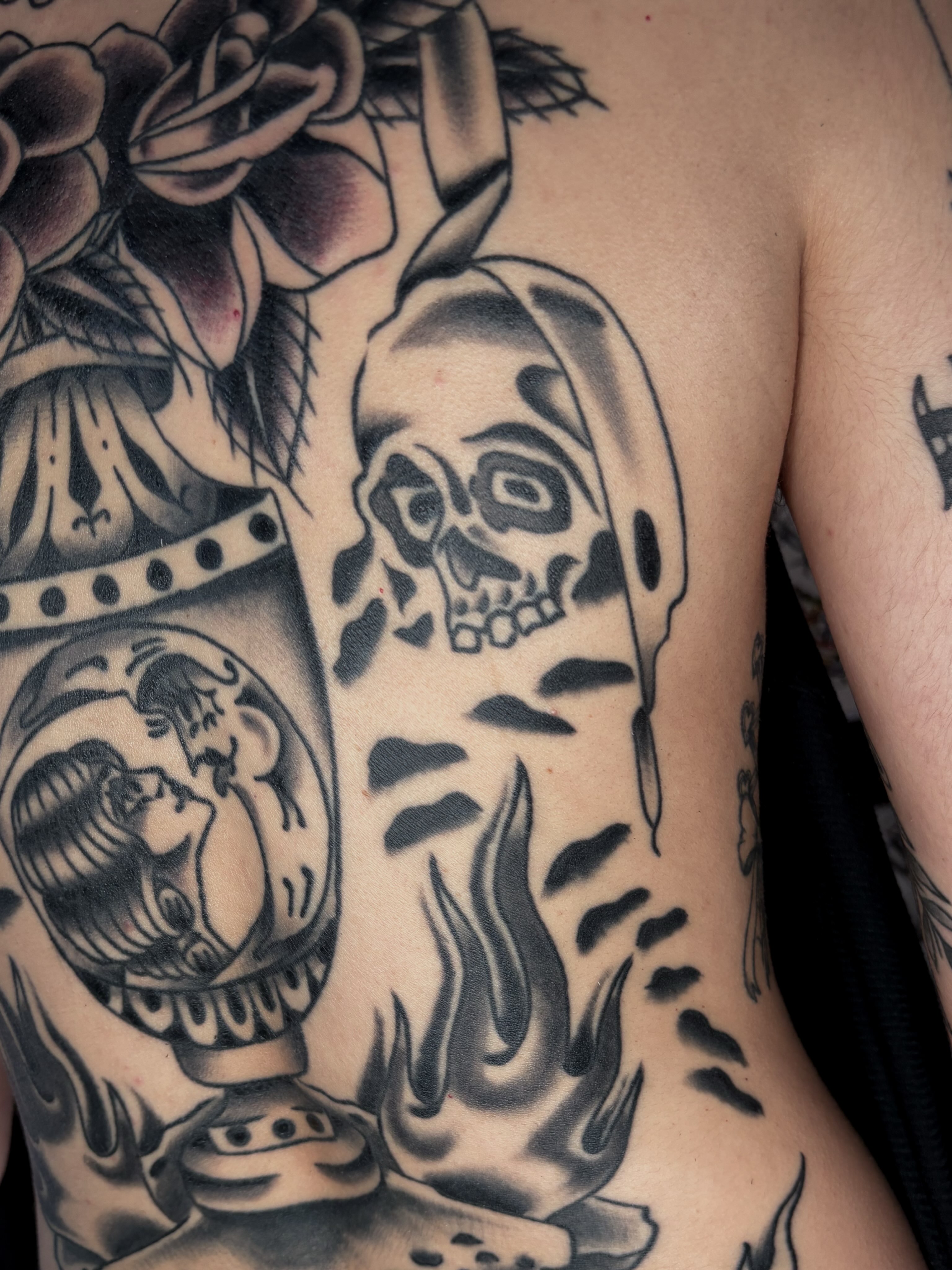 Skull and flame American traditional tattoo on the chest by Evan Bisso, Philadelphia, Pennsylvania