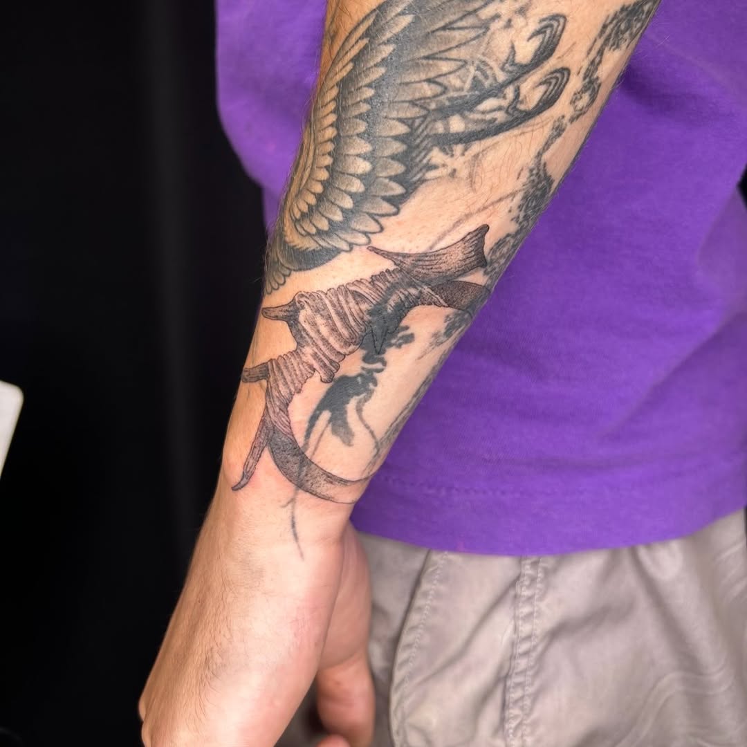 Barbed wire and skull sketch tattoo on the forearm by Jadin Nichols