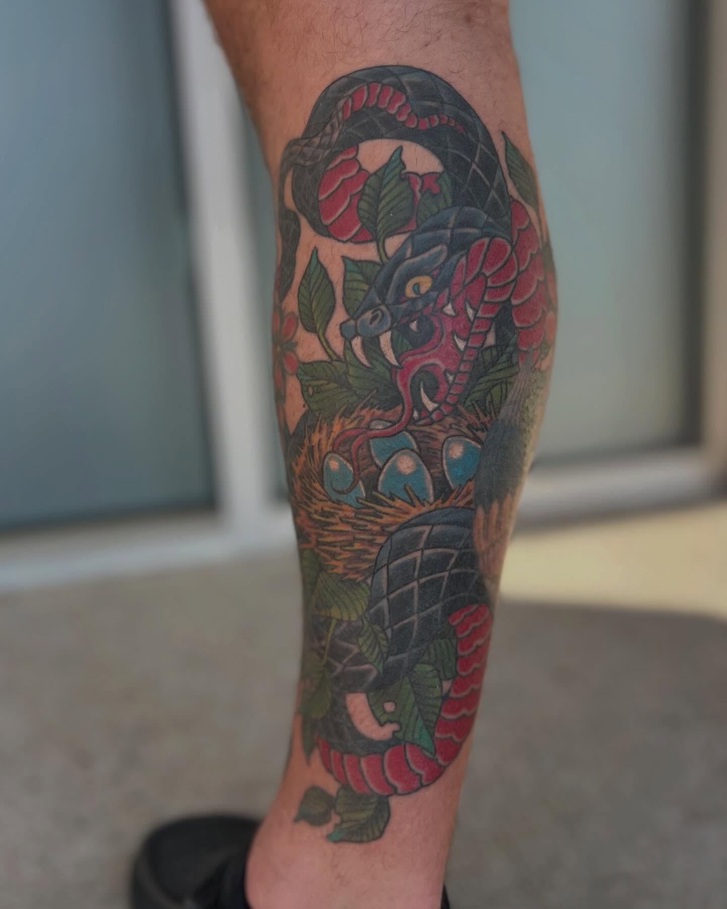 Snake and peony American traditional tattoo on the forearm by Jesse Gray