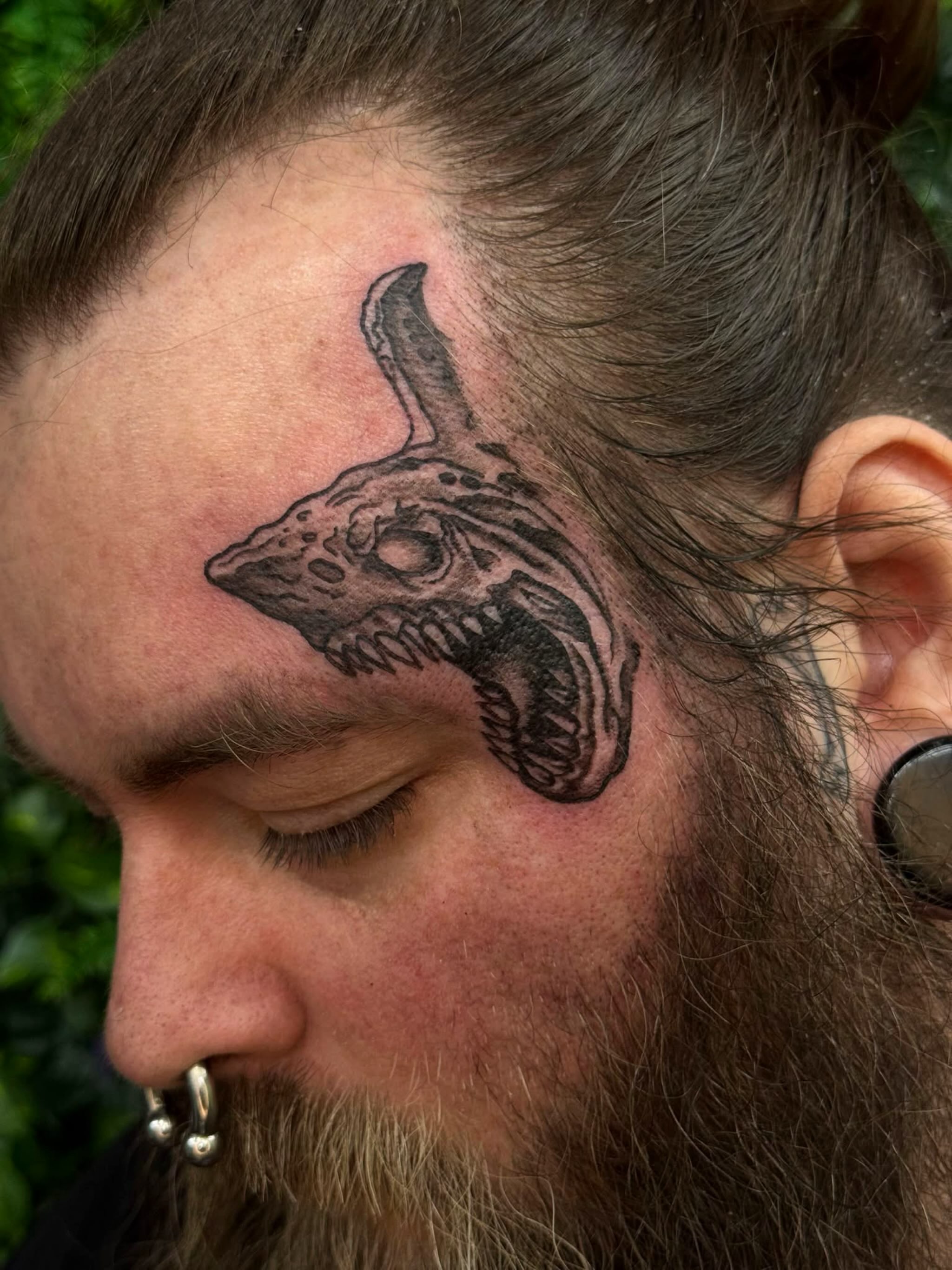 Dinosaur skull black and grey tattoo on the head by Sabrina