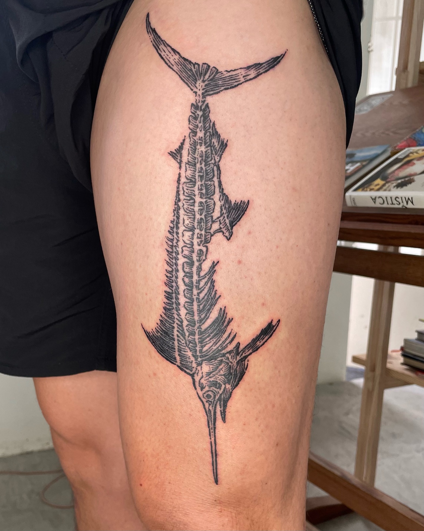 Swordfish skeleton black and grey tattoo on the thigh by Anh Đan