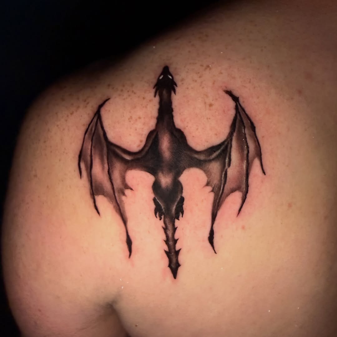 Dragon blackwork tattoo on the shoulder by Erin Peterson