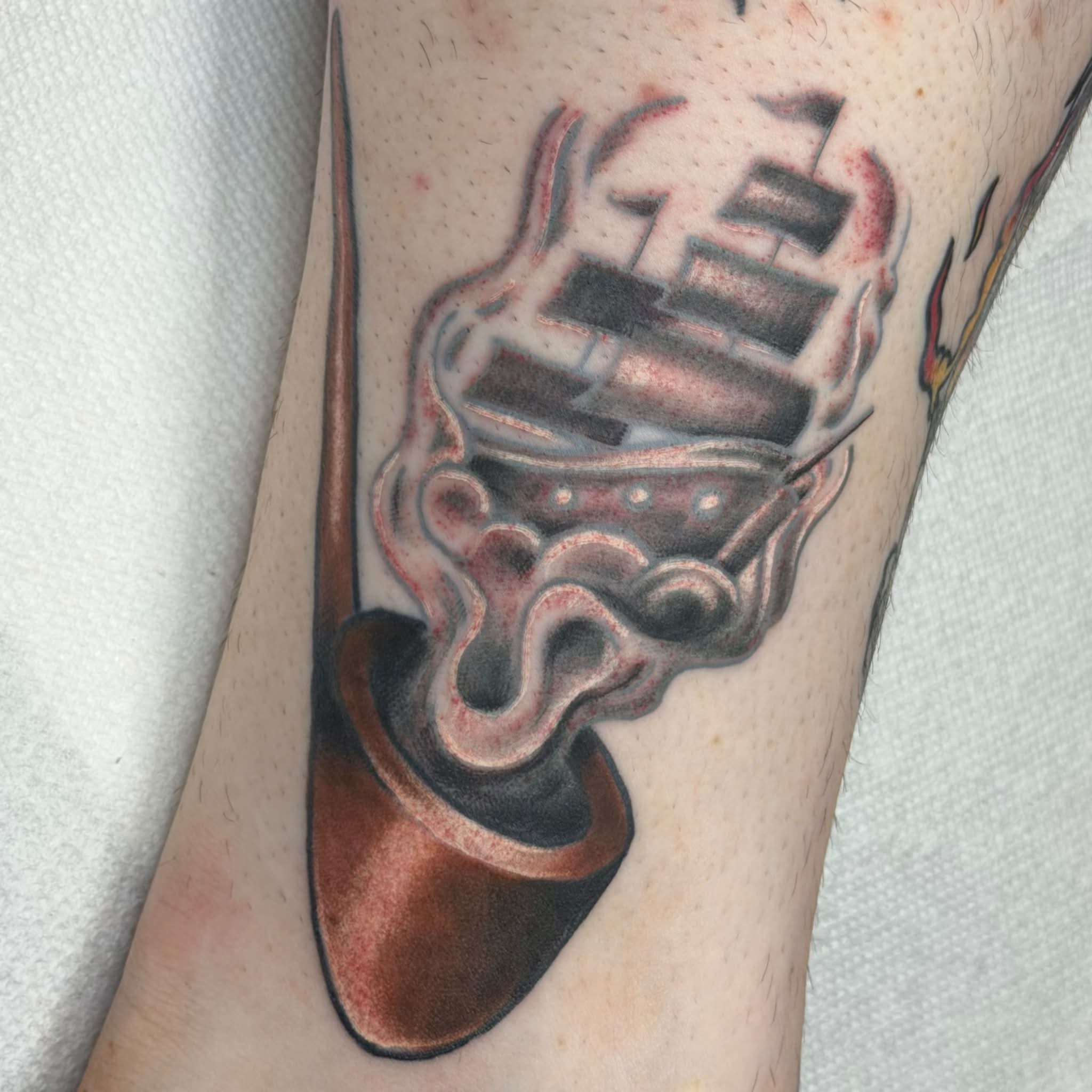 Smoking pipe realism tattoo on the forearm by Kenneth Prince