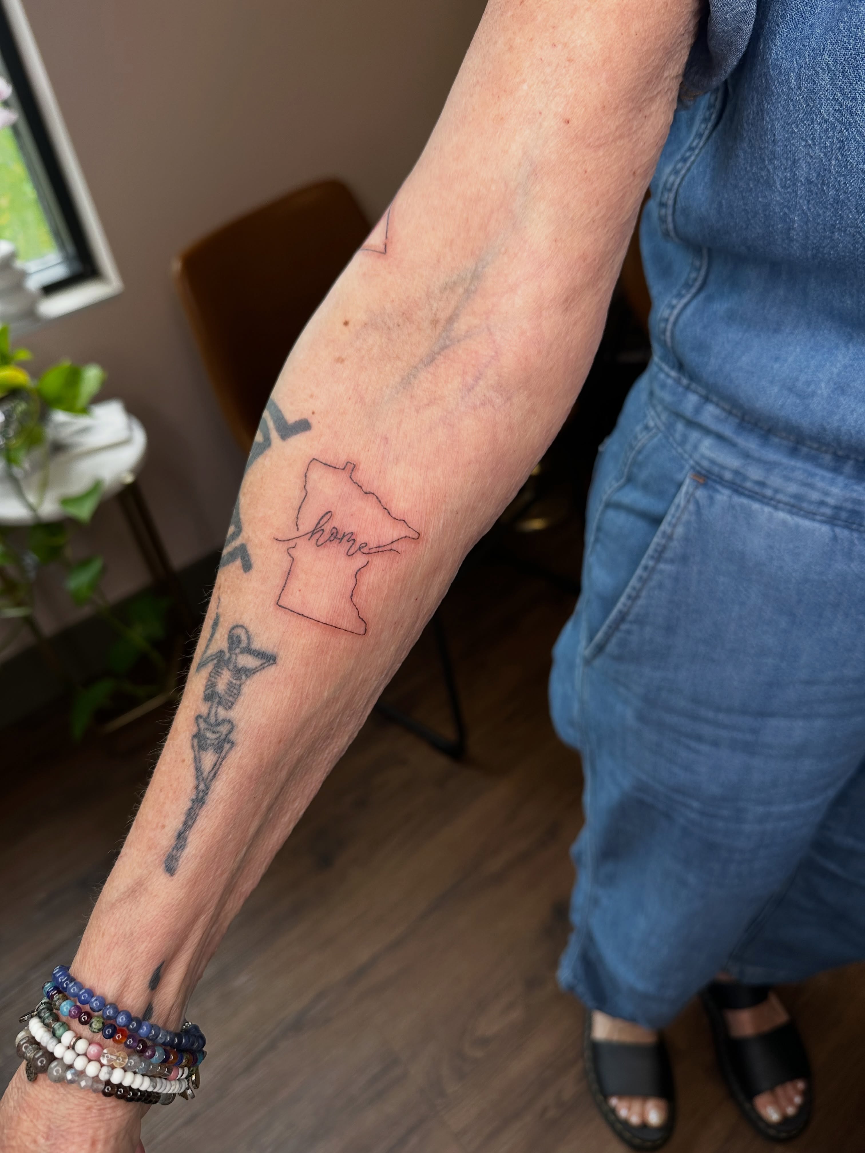 Wisconsin outline fine line tattoo on the forearm by Liz