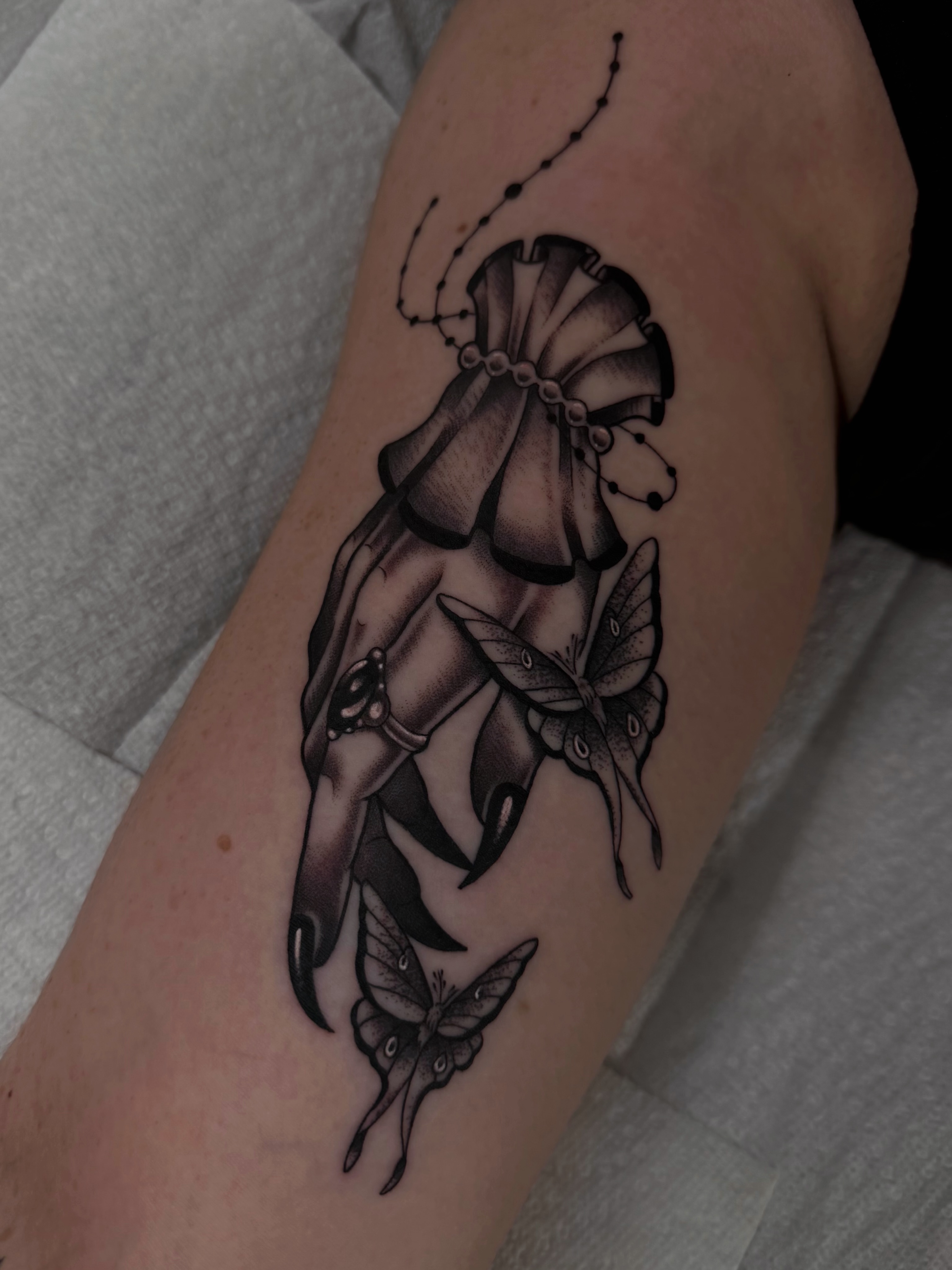 Bell and butterflies black and grey tattoo on the forearm by Sacramento Tattoos (Ilona)