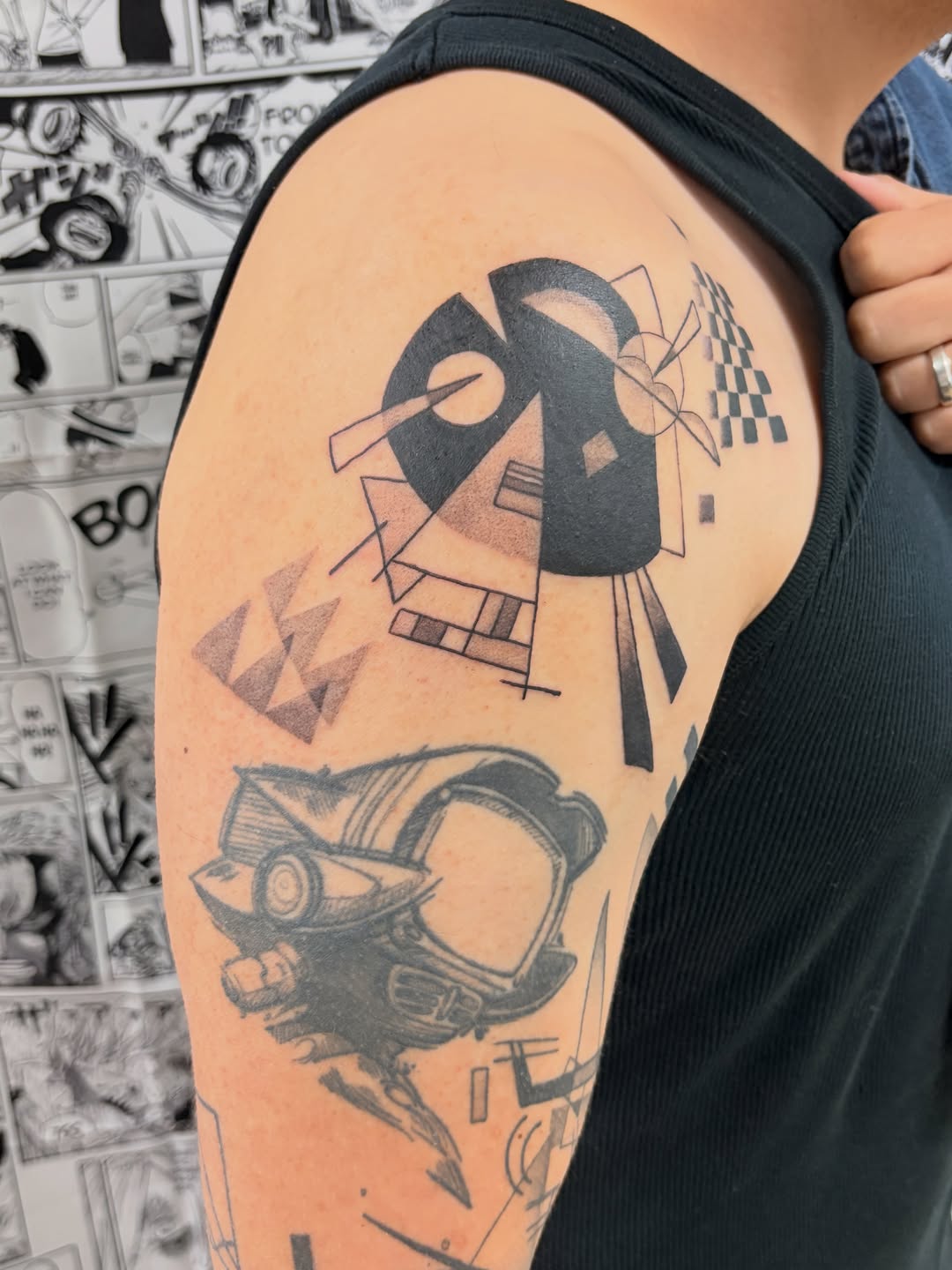 Abstract geometric design and robot helmet tattoo on the upper arm by Chris, Cleveland, Ohio