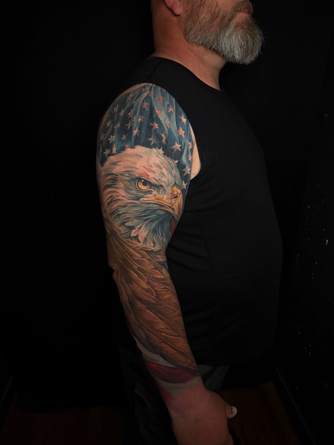 Eagle and american flag realism tattoo on the upper arm by Brad Snow