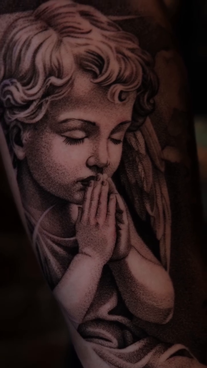 Praying cherub angel realism tattoo on the forearm by Ana Fajardo