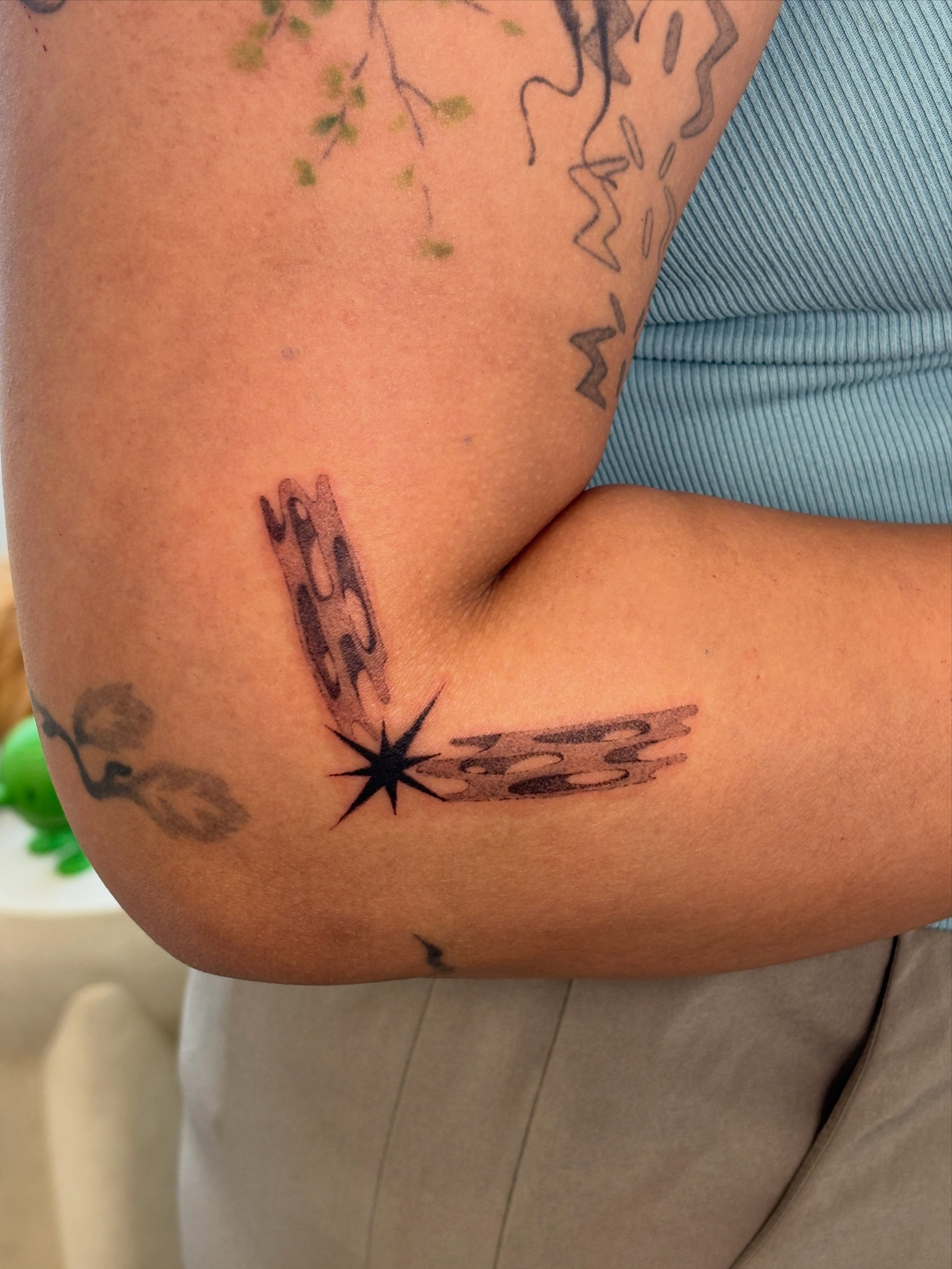 Starburst with abstract shapes black and grey tattoo on the forearm by ꜱʜɪʀʟᴇʏ