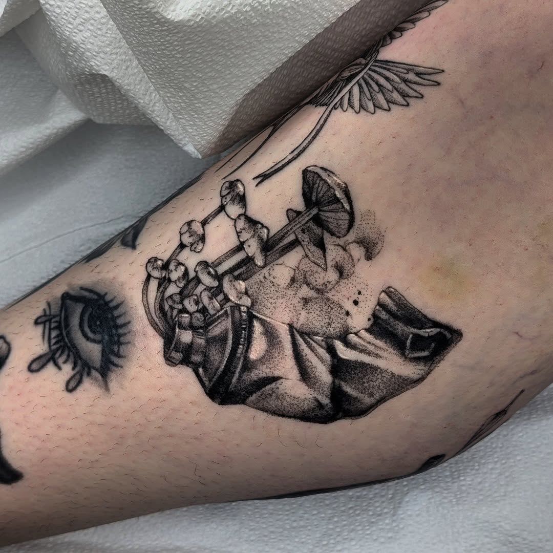 Hand holding mushrooms surrealism tattoo on the forearm by ʀᴇɴ ᴛʀᴏᴜᴠᴀɪʟʟᴇ