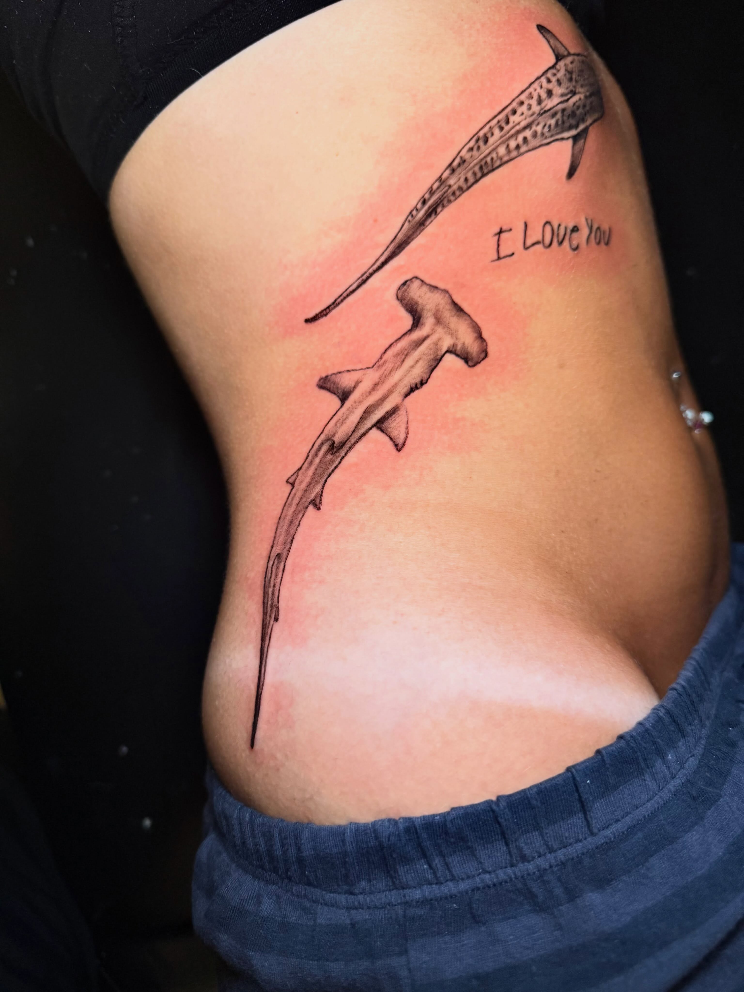 Hammerhead sharks black and grey tattoo on the ribs by Adam Newton