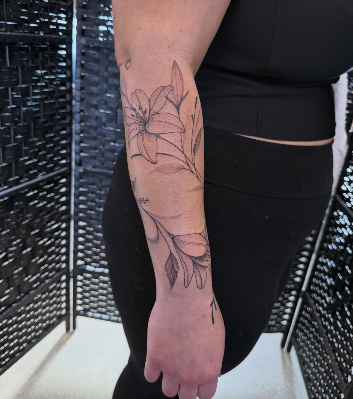 Lily black and grey tattoo on the forearm by WhoisLaineyTattoos