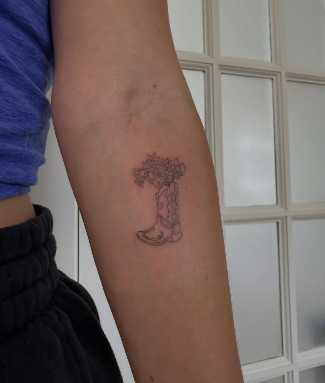 Cowboy boot with flowers black and grey tattoo on the forearm by Lexie Decker, Canton, Ohio