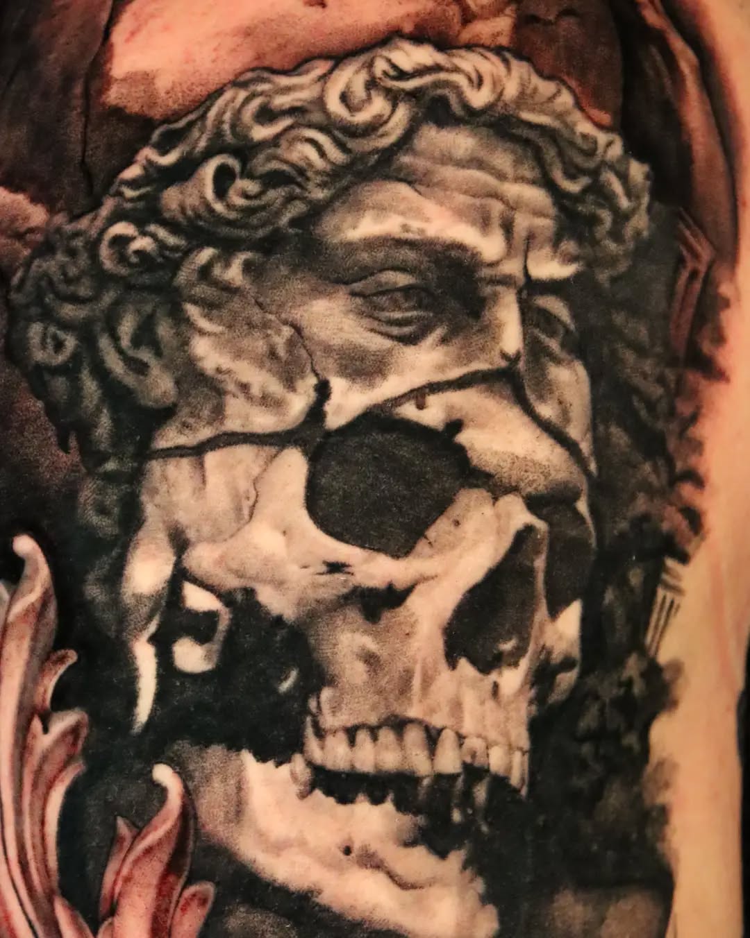 Cracked skull and face sculpture dark art tattoo on the forearm by Miami Florida Tattoo Artist