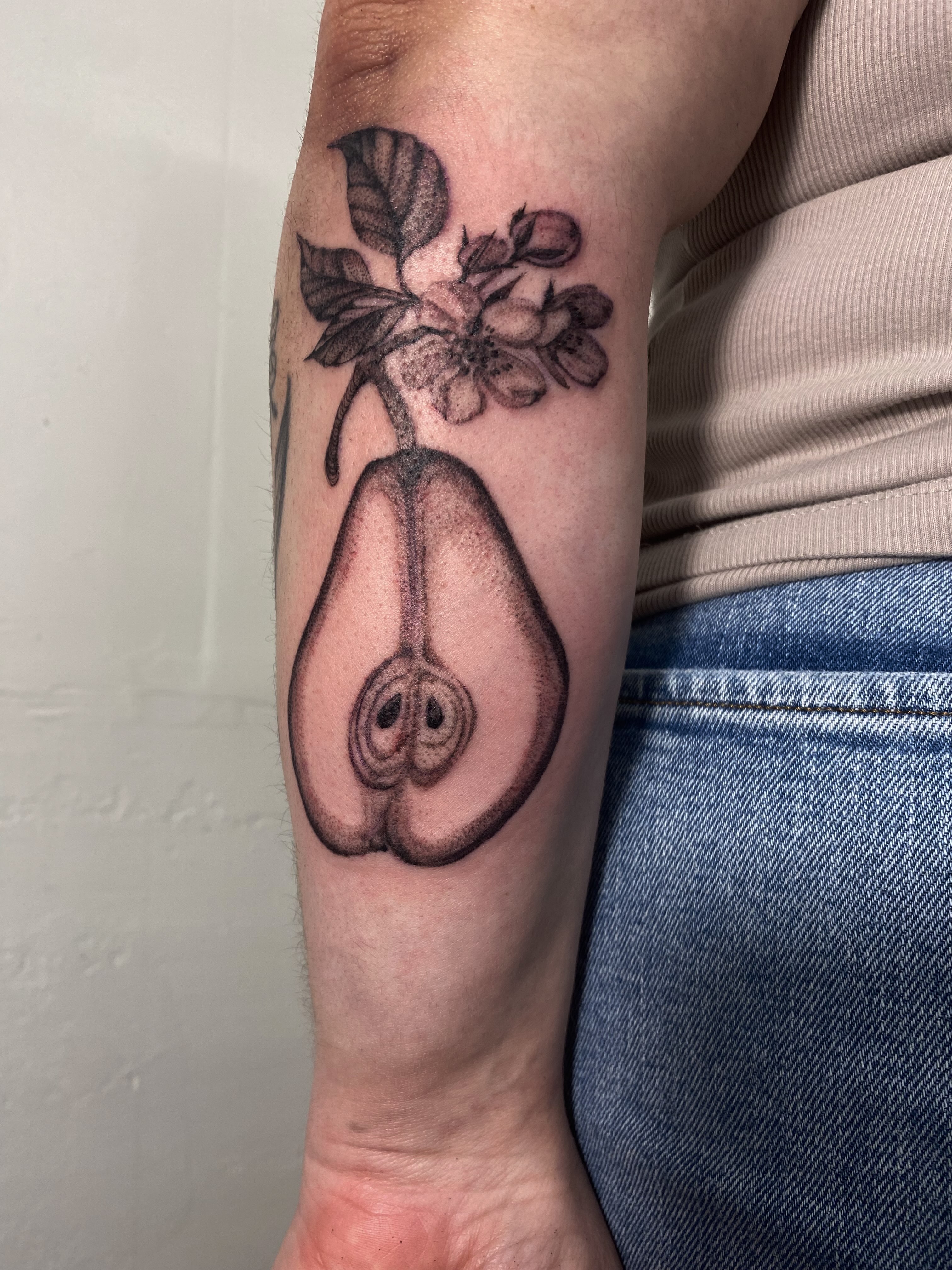 Pear with flowers dotwork tattoo on the forearm by Tianna Osborne
