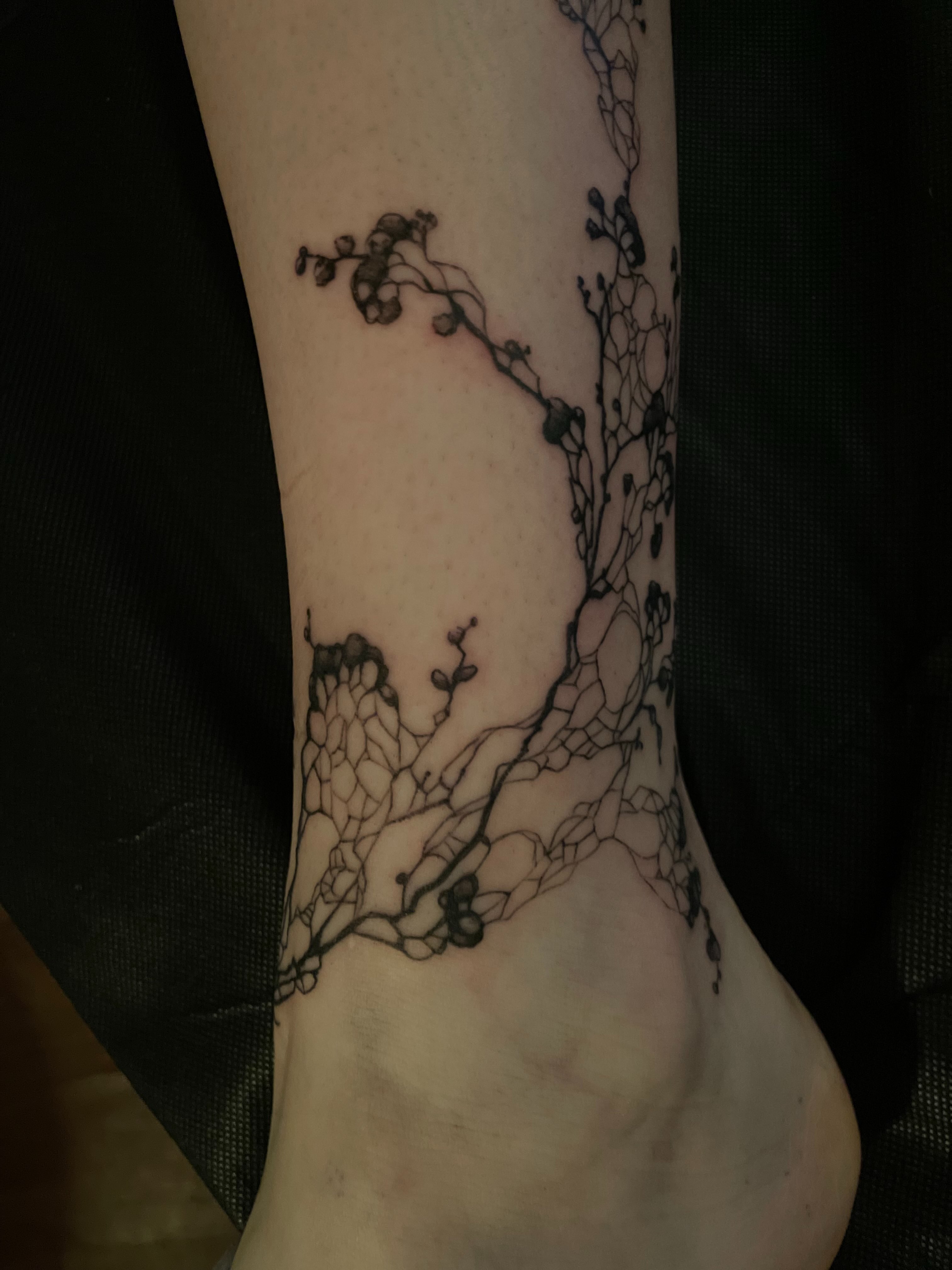 Abstract vine black and grey tattoo on the foot by Jacob Kearney