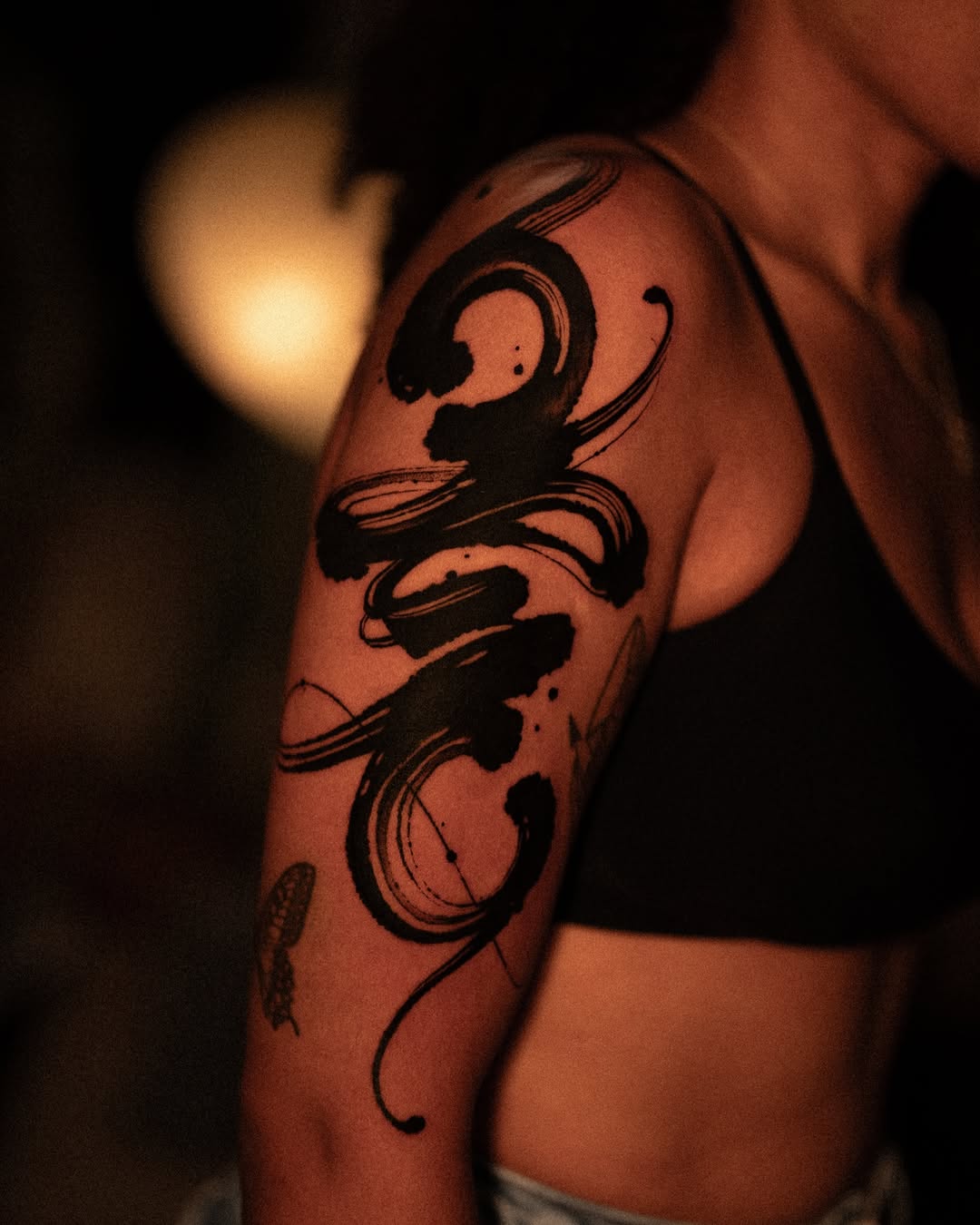 Abstract brush stroke blackwork tattoo on the upper arm by Low, Brooklyn, New York