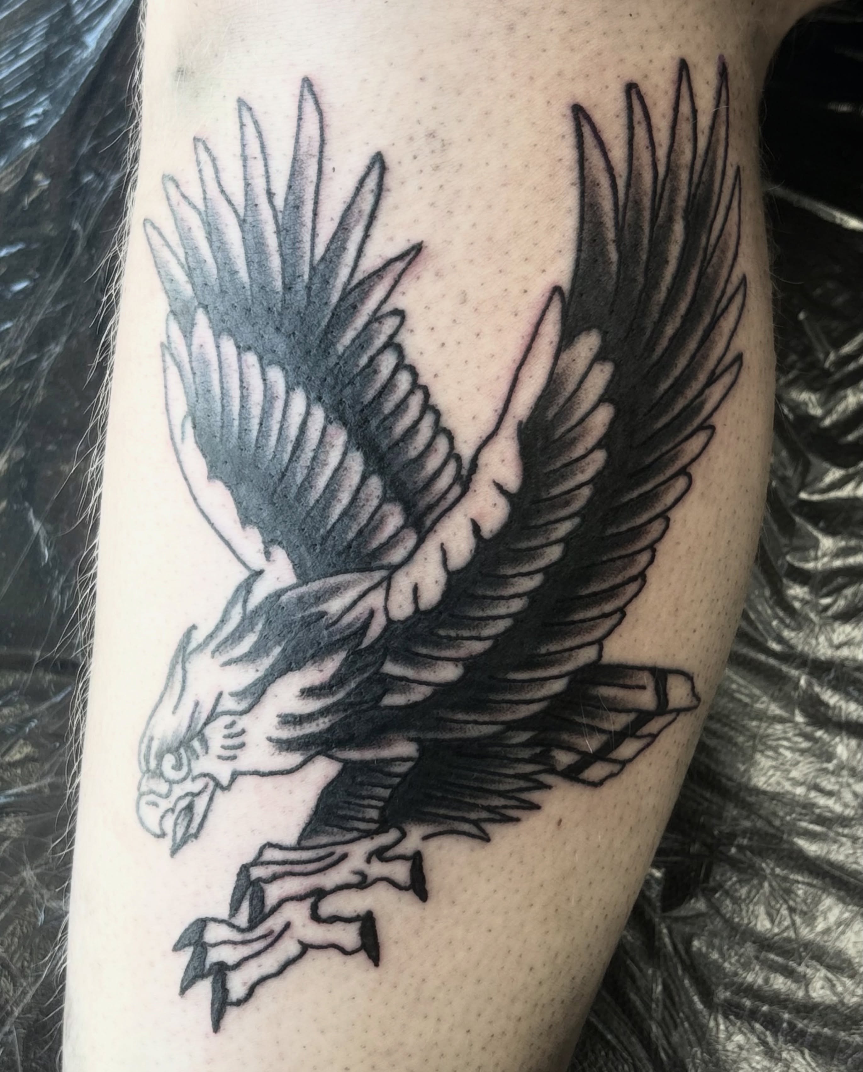 Eagle black and grey tattoo on the forearm by Landon Bagley