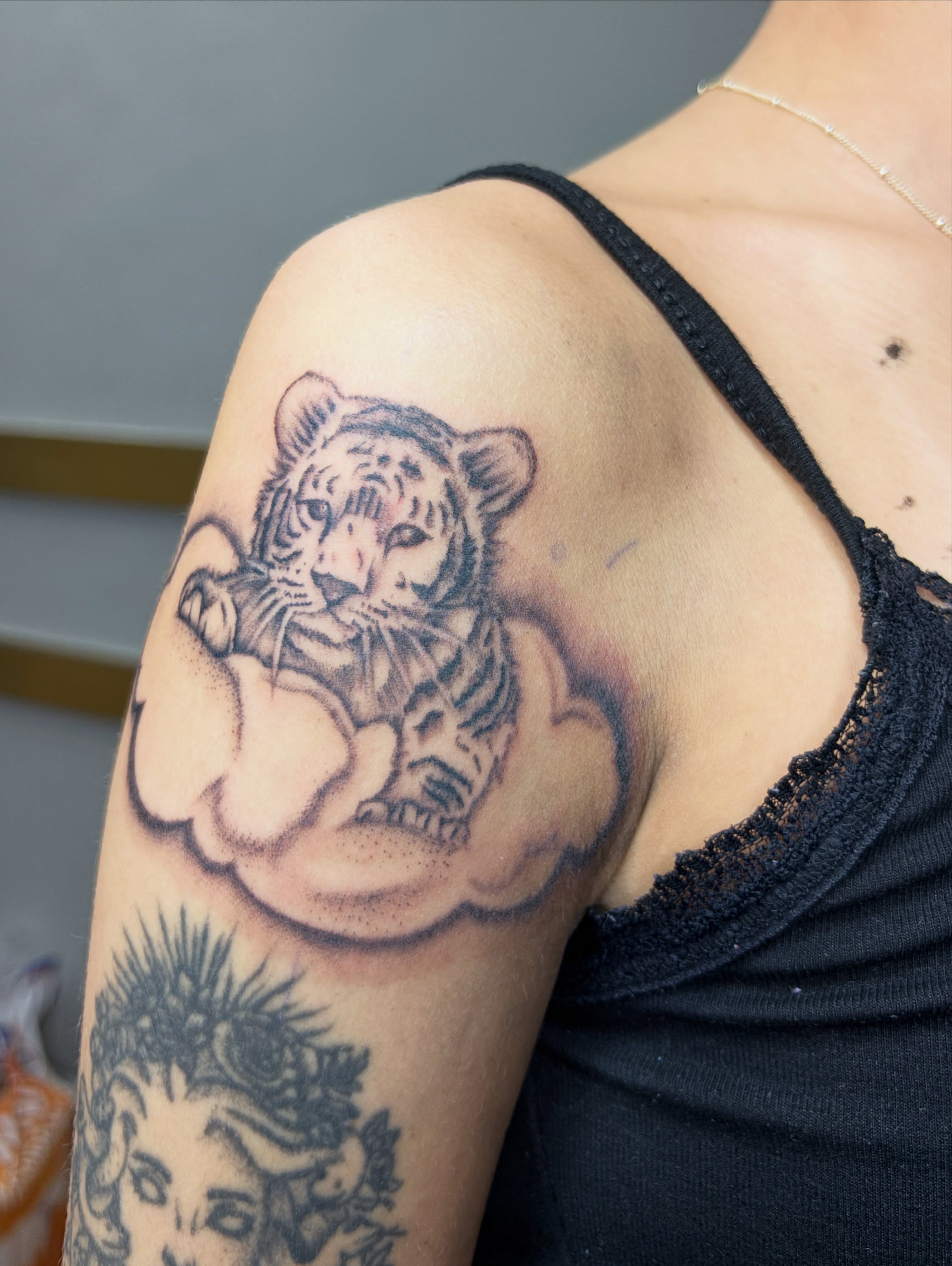 Tiger black and grey tattoo on the shoulder by Destineé