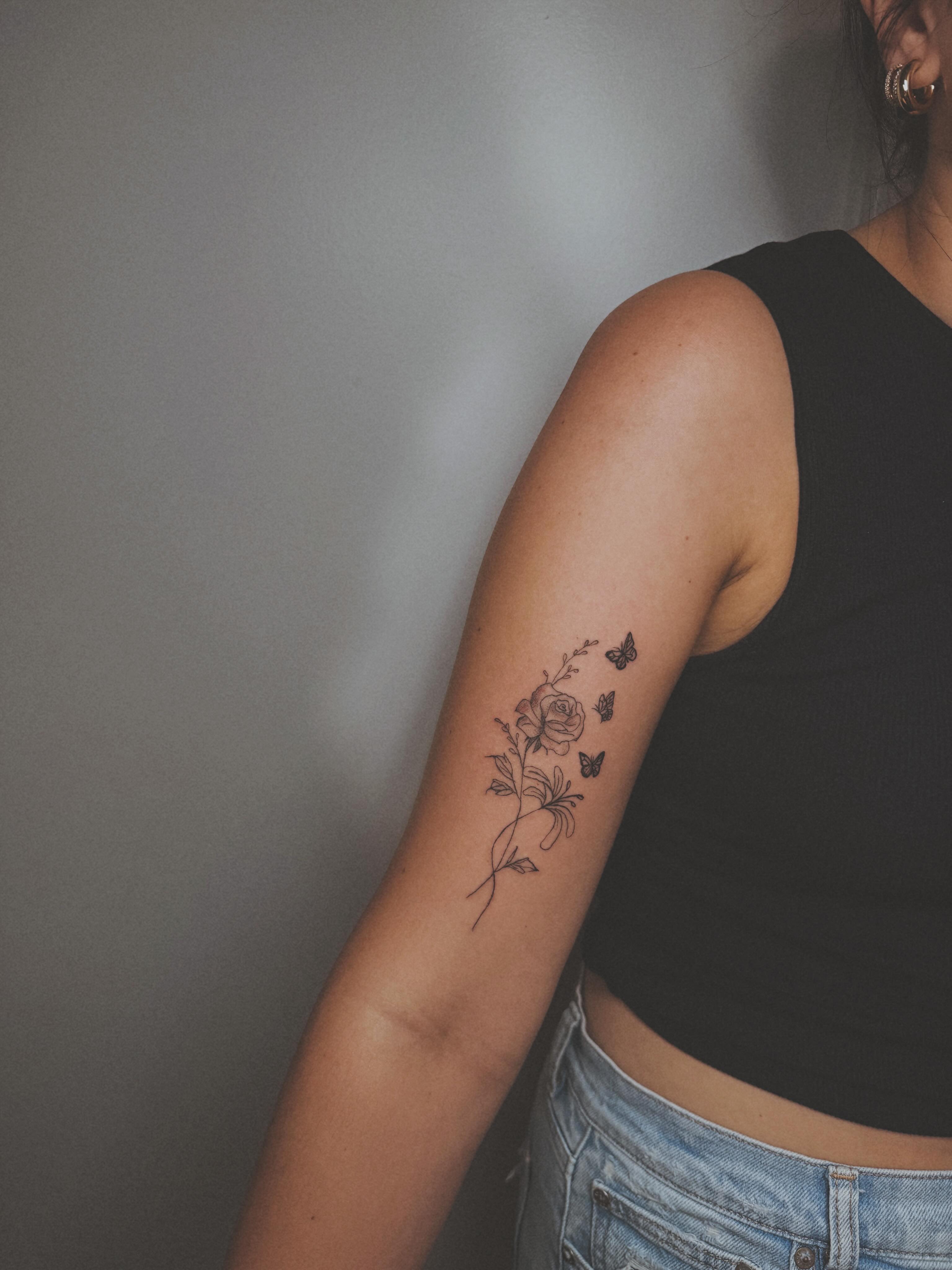 Floral arrangement black and grey tattoo on the forearm by Ashlee Burkey
