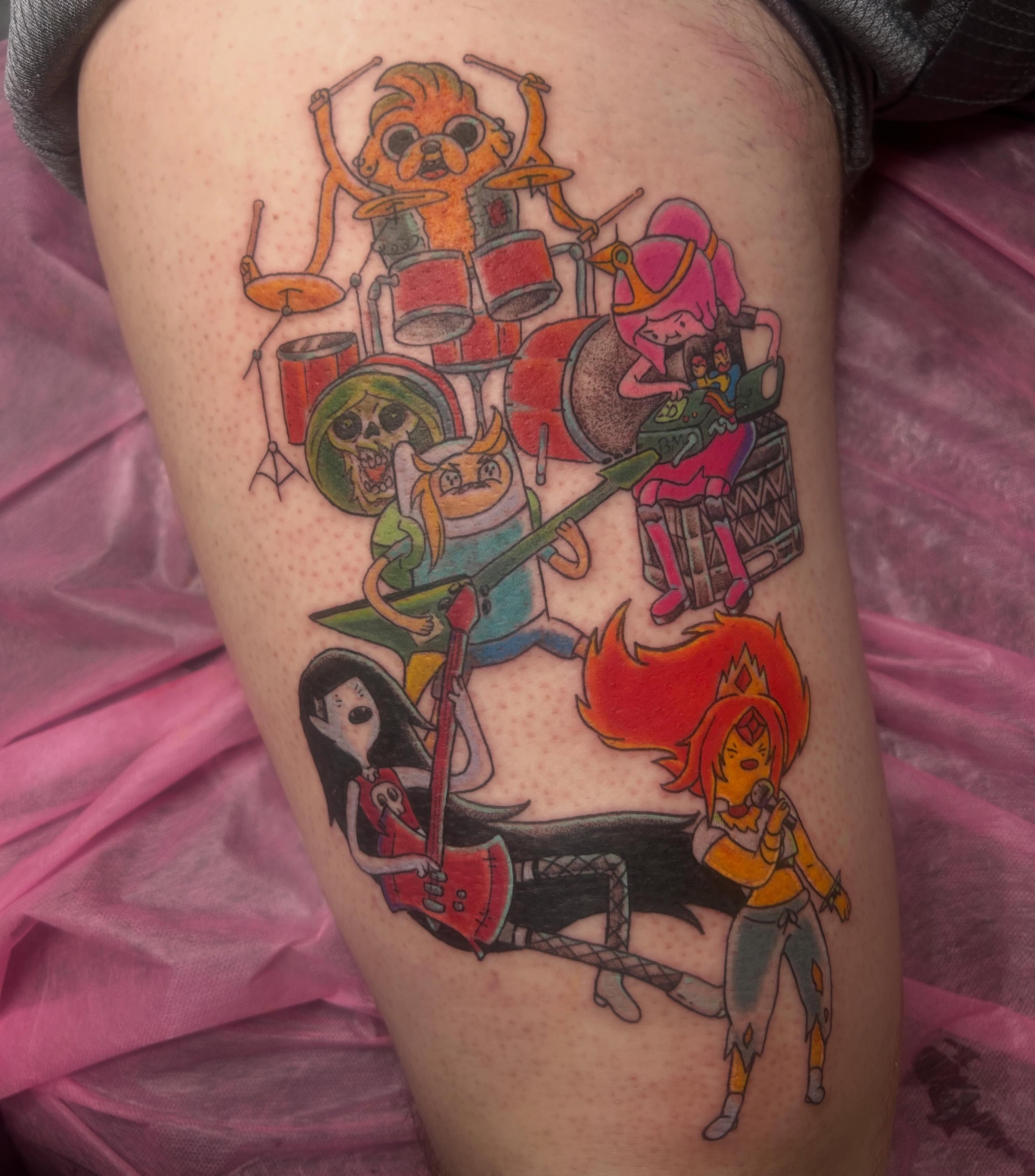 Music band characters anime tattoo on the thigh by Reilley Earles