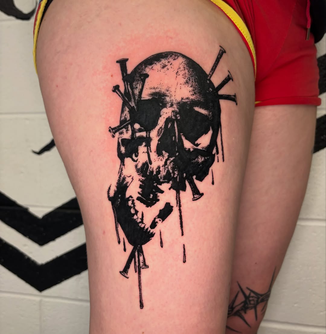 Skull with nails black and grey tattoo on the thigh by @lil_stinker_5000, Portland, Oregon