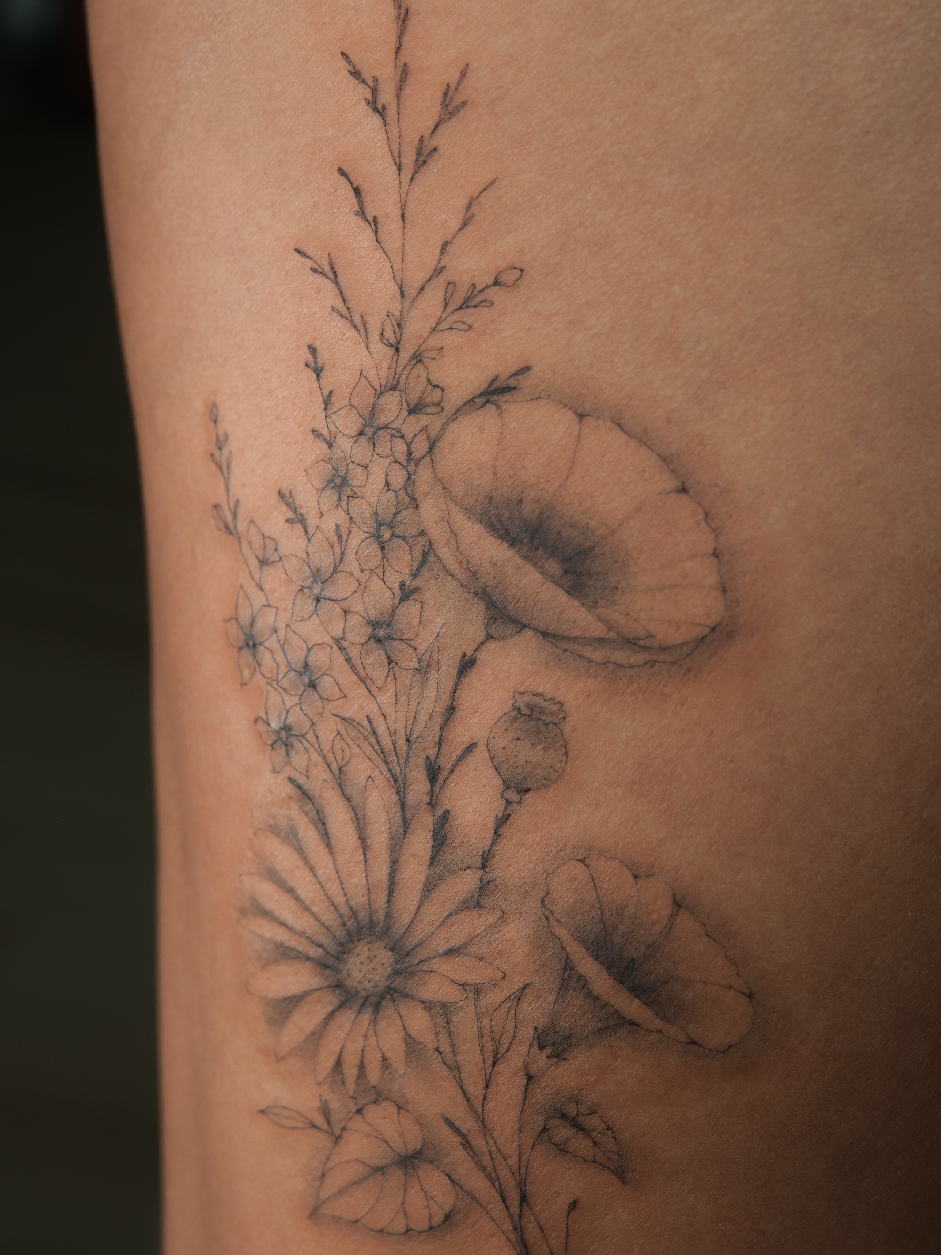 Floral arrangement realism tattoo on the forearm by Victoria