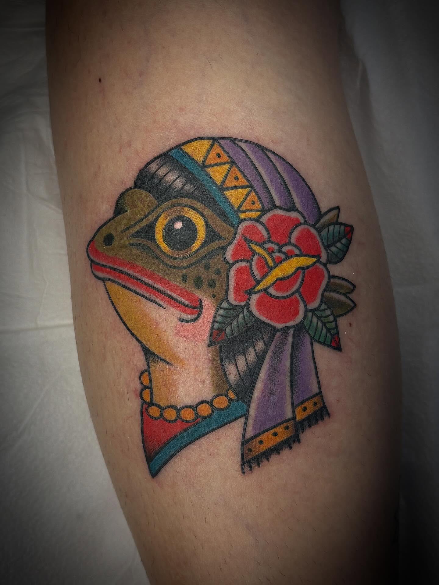 Mask with floral ornament American traditional tattoo on the thigh by Gardner, Gardner, Massachusetts
