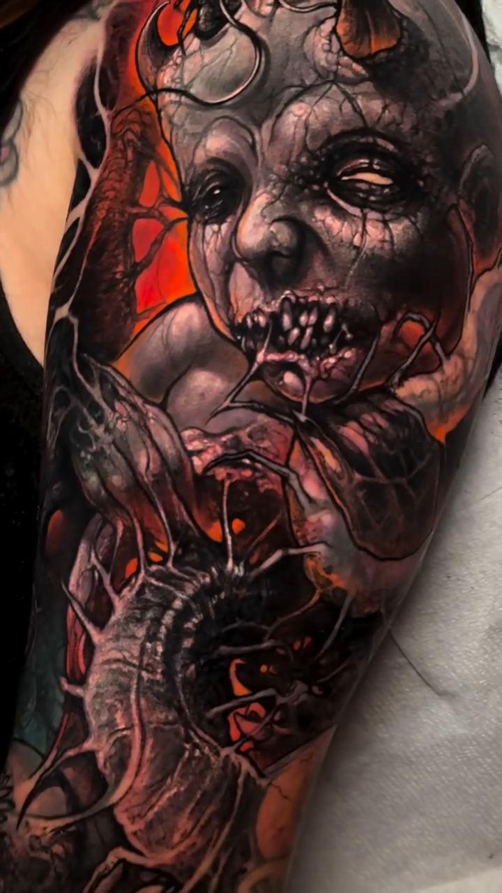 Demonic creature and eye dark art tattoo on the upper arm by Brandon Herrera
