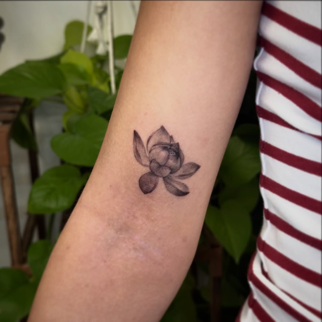 Lotus flower sketch tattoo on the forearm by Xin Huang