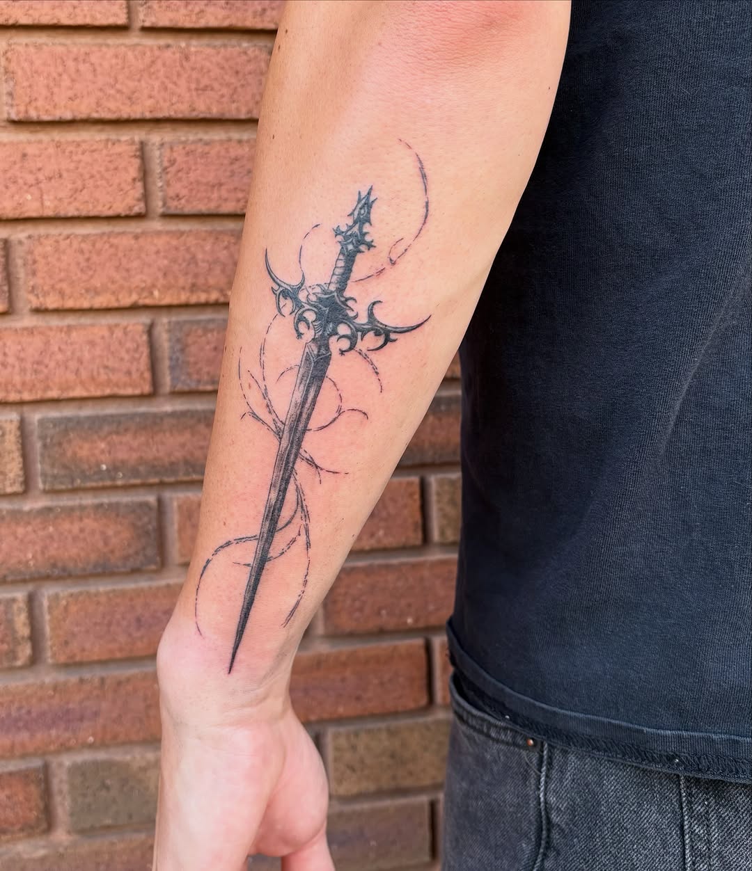 Ornate sword cyber sigilism tattoo on the forearm by Sierra Maynard