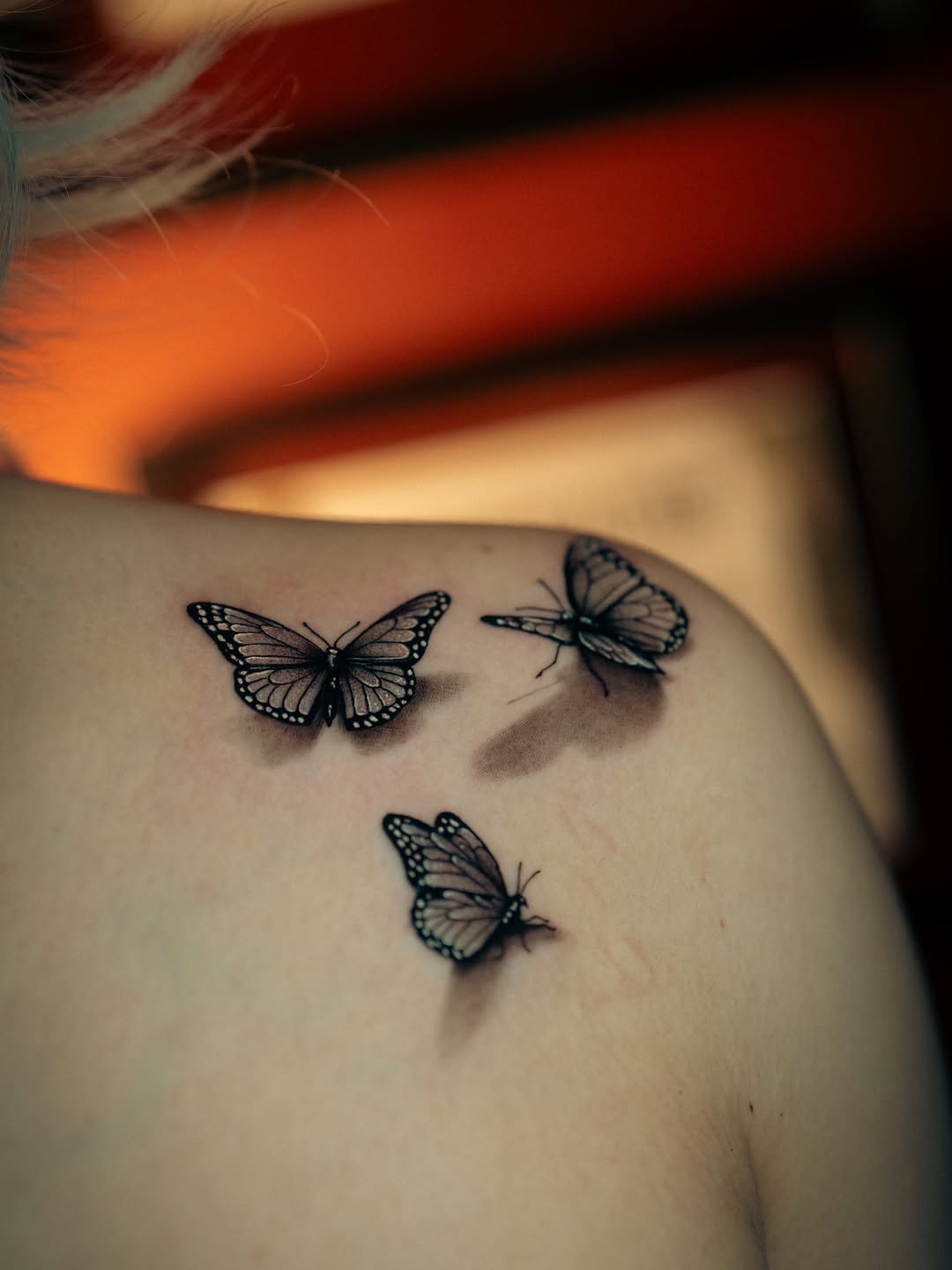 Butterflies fine line tattoo on the shoulder by Franz Muñoz