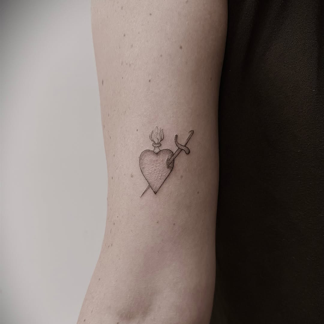Heart with arrow black and grey tattoo on the forearm by Chanel Picquelle, Nashville, Tennessee