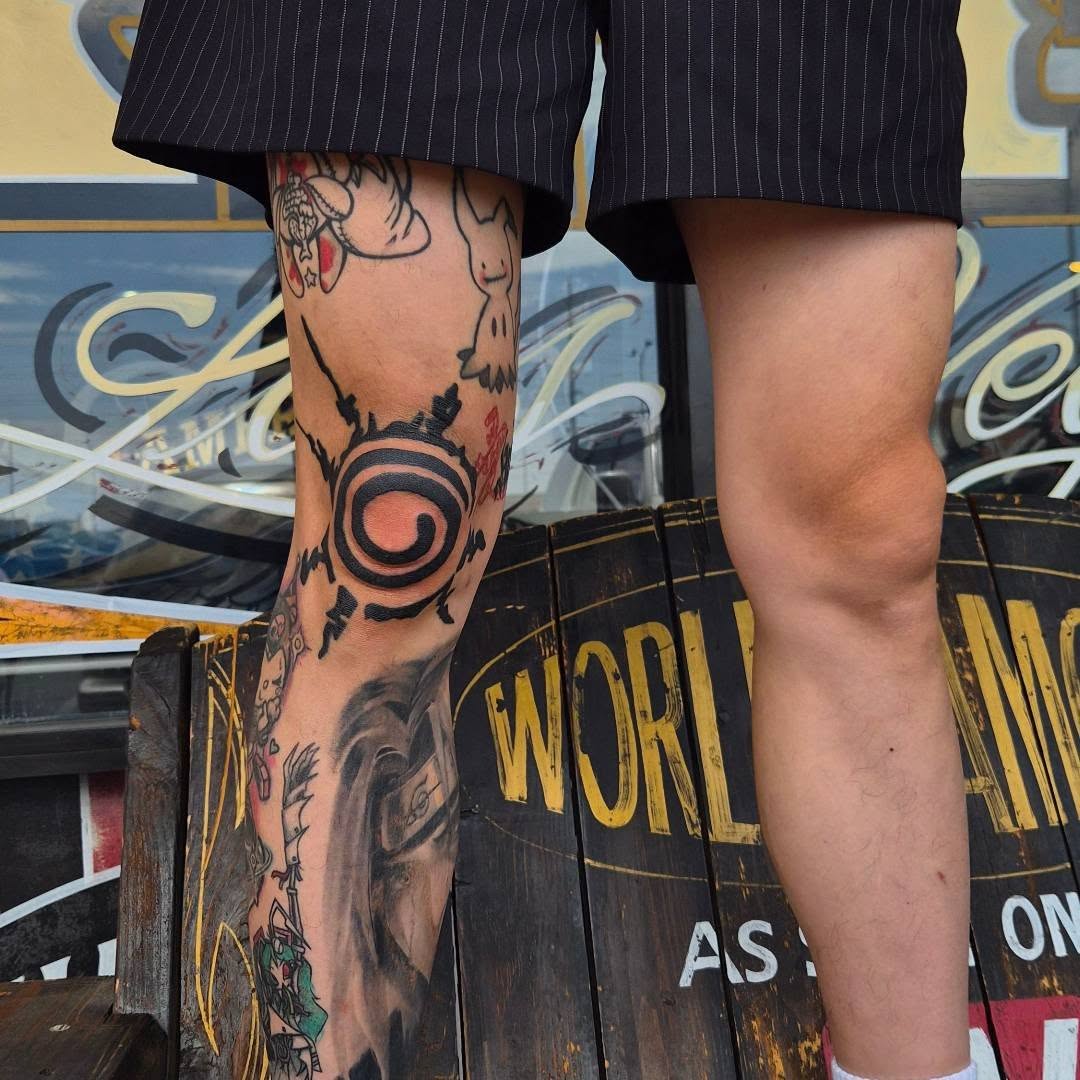 Stylized spiral symbol tattoo on the leg by Cielle