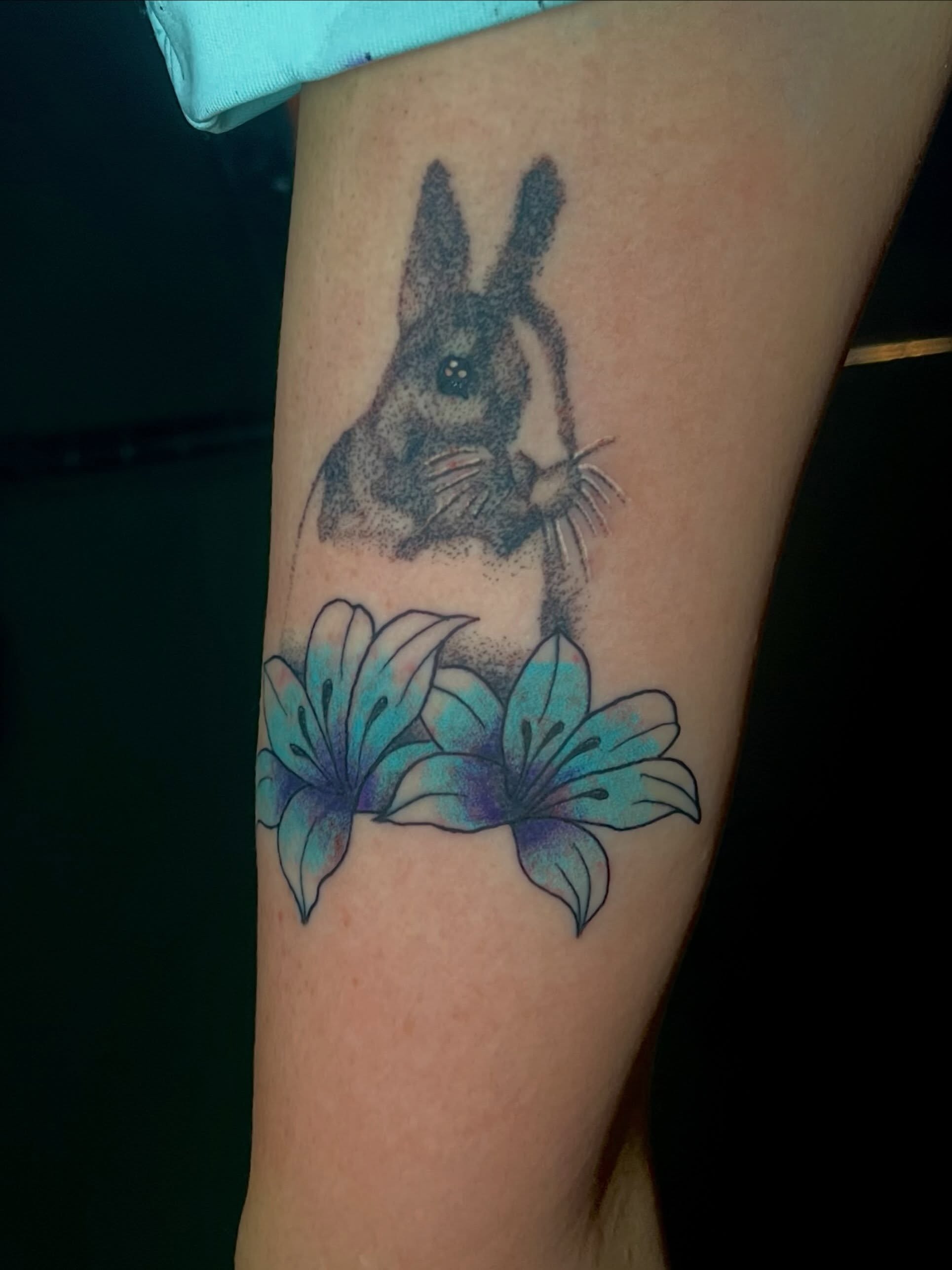 Rabbit and flowers dotwork tattoo on the forearm by Mason McCubbin