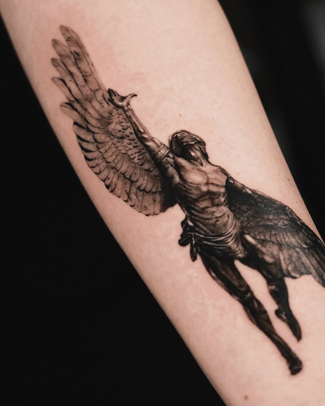 Angelic figure realism tattoo on the forearm by Seraph Geometry