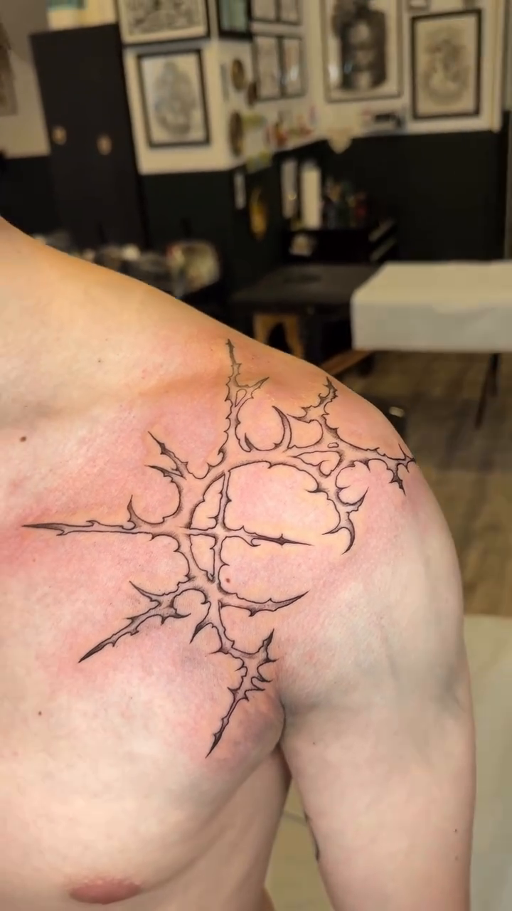 Abstract thorny design blackwork tattoo on the chest by Seattle Cybersigilism Tattoo Horror