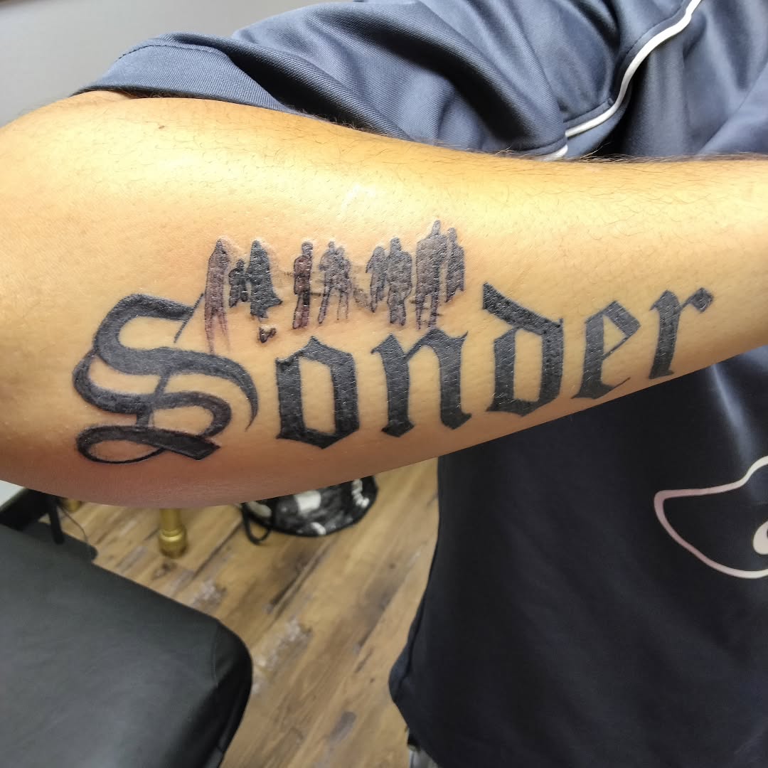 Sonder with silhouettes tattoo on the forearm by Malynda