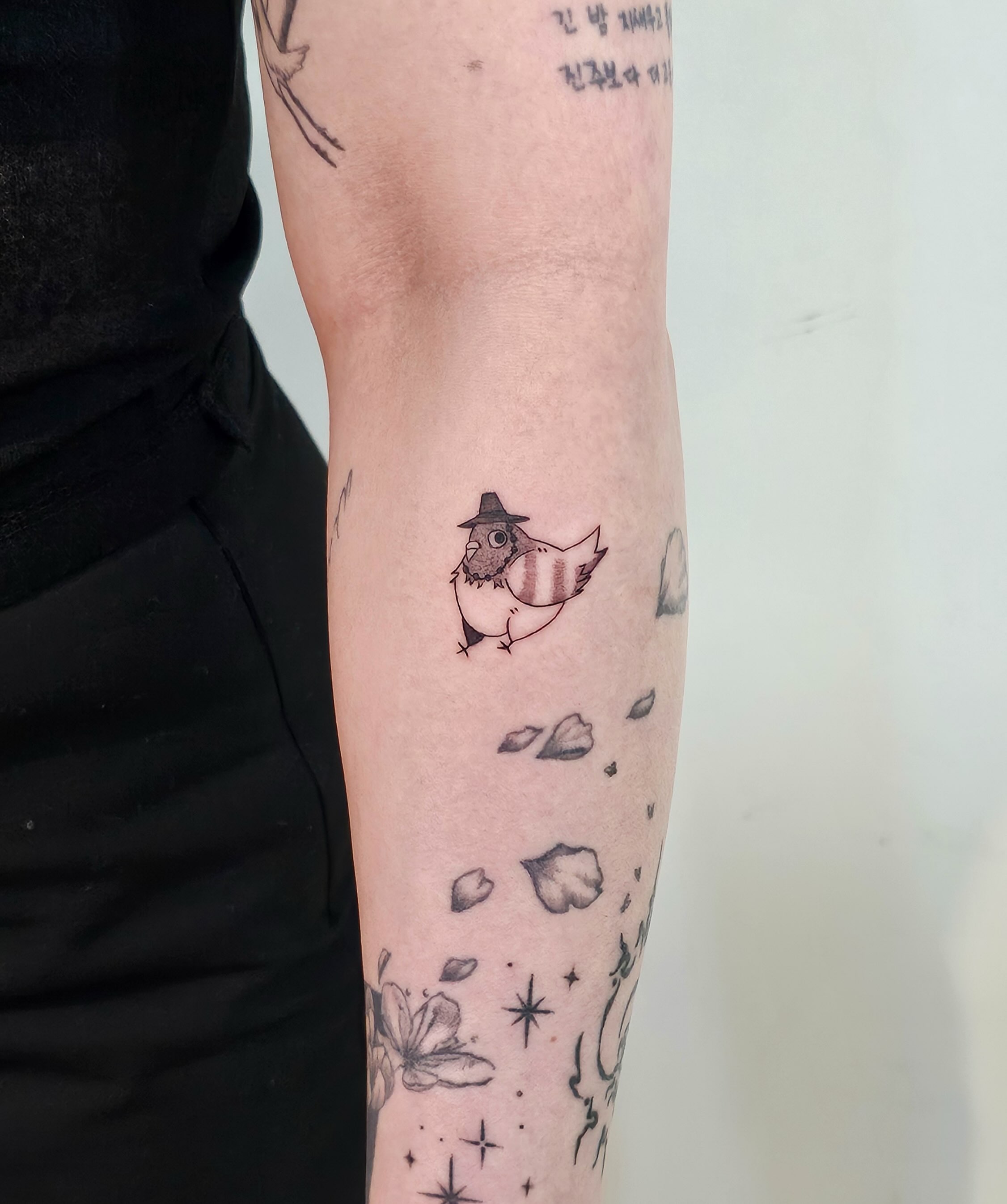 Fish wearing hat black and grey tattoo on the forearm by Taeyeon▪️Tattoos are literature🇰🇷