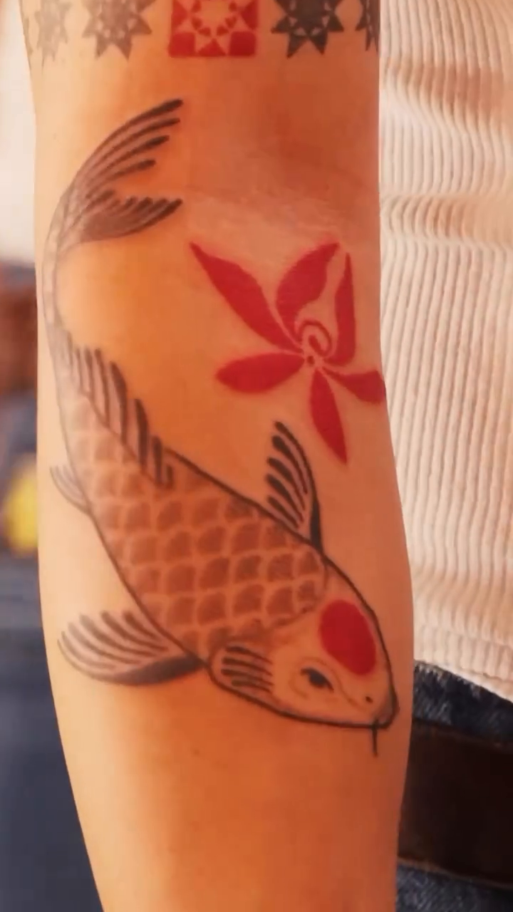 Koi fish with floral elements Japanese tattoo on the upper arm by faith