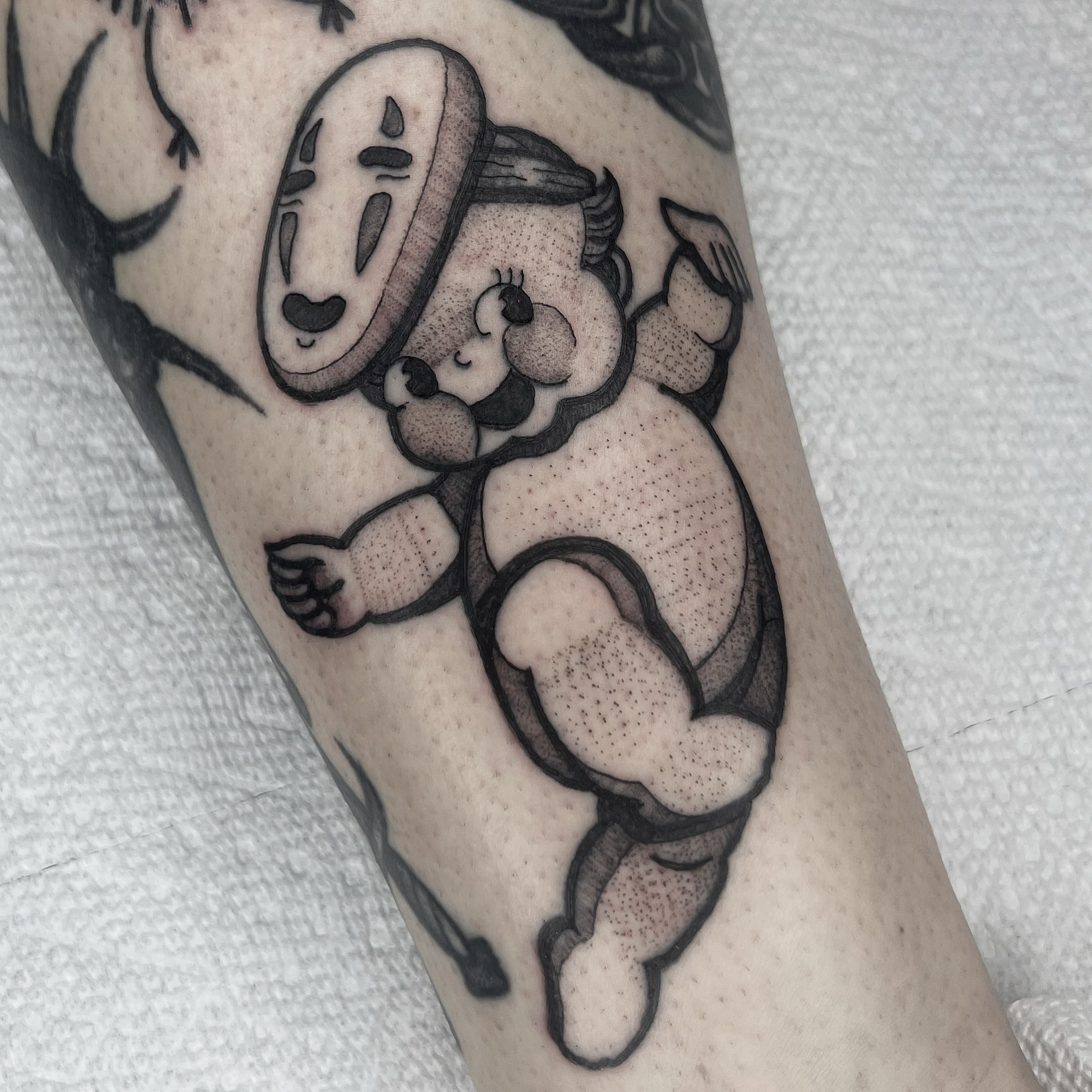 No face character and child dotwork tattoo on the forearm by 𝑴𝑬𝑮𝑨𝑵 𝑪𝑳𝑰𝑭𝑻𝑶𝑵, Cincinnati, Ohio