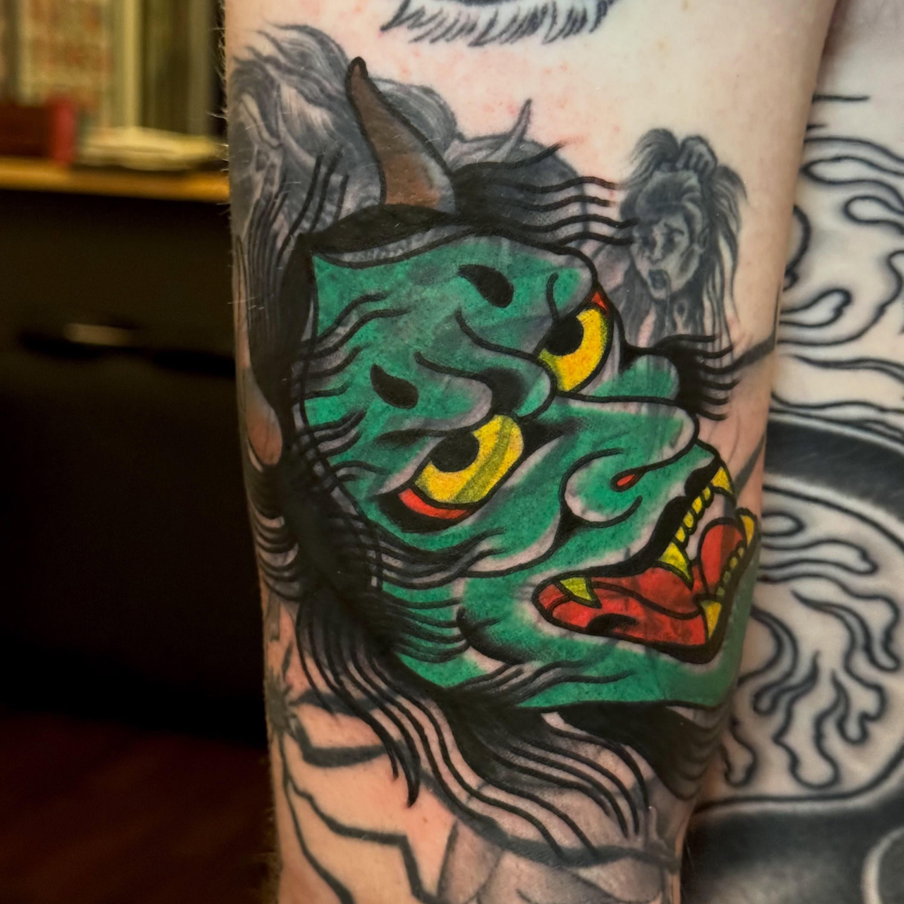 Demon face American traditional tattoo on the forearm by Eli Bernal