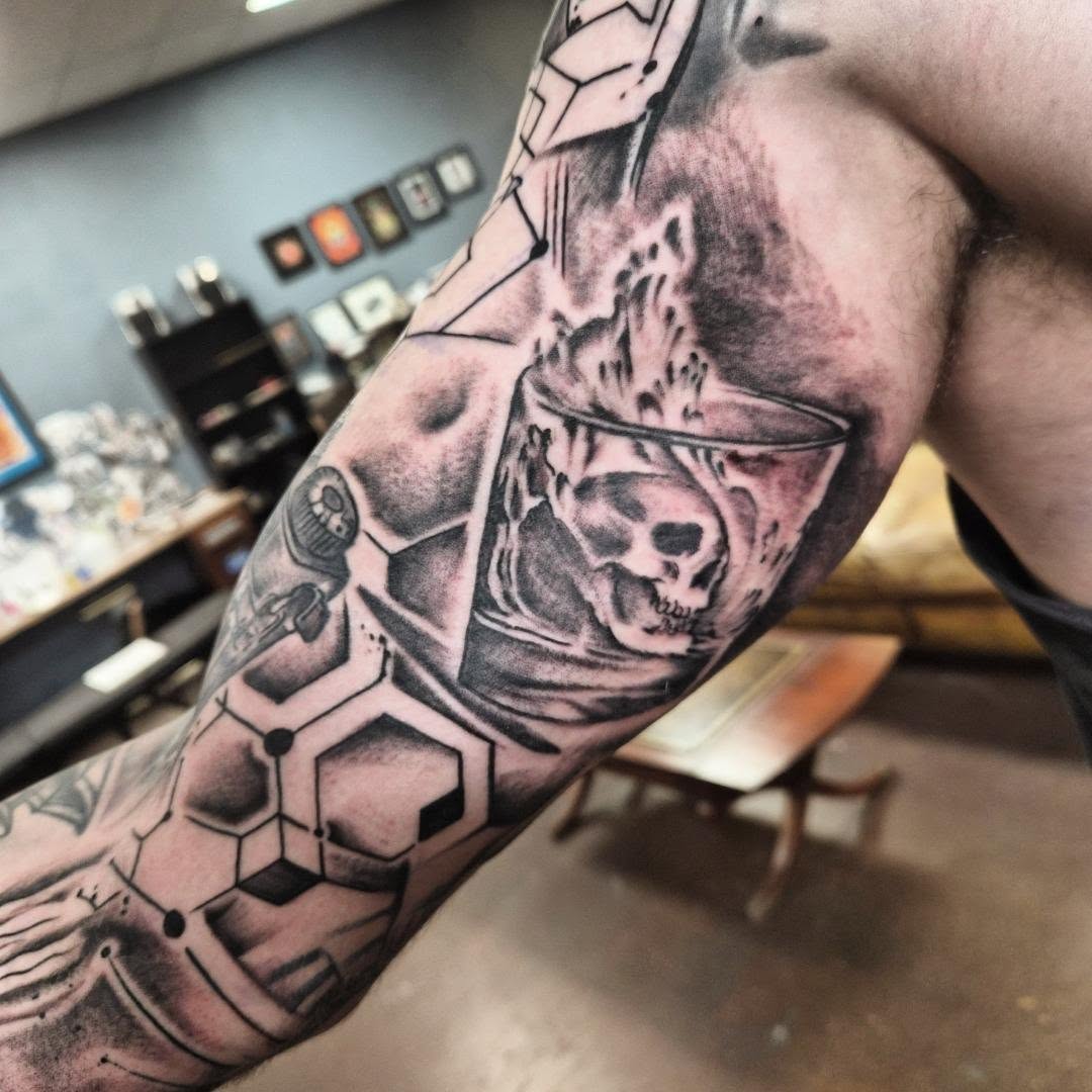 Chemical structure with skull geometric tattoo on the forearm by Taylor Popkins