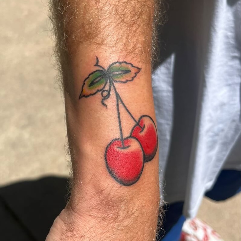 Cherry American traditional tattoo on the forearm by Béle Benard