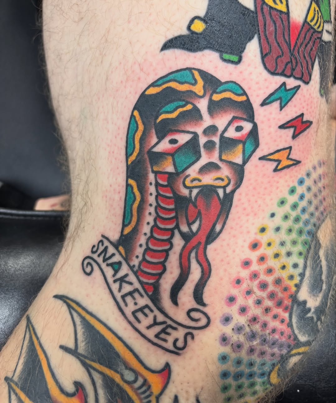 Snake eyes American traditional tattoo on the forearm by Steve Reid